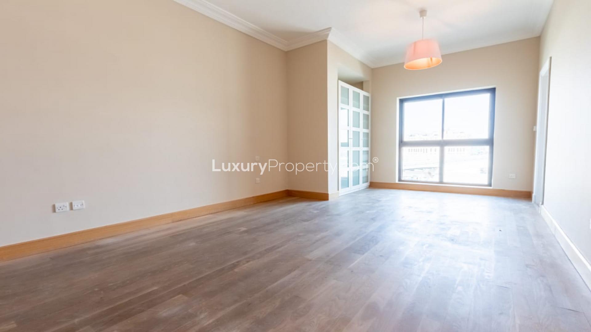 Bright, spacious living room in upgraded Palm Jumeirah apartment with wooden flooring