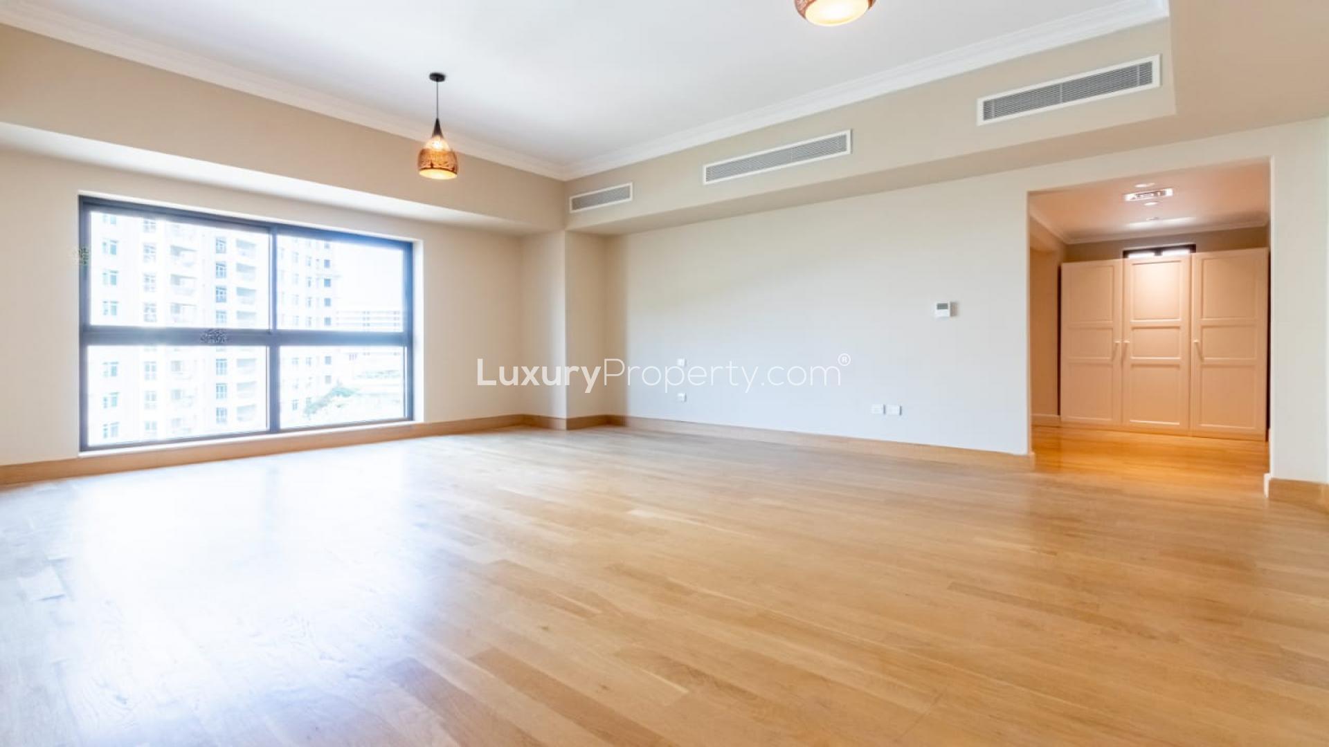 Luxurious living room in upgraded Golden Mile apartment, Palm Jumeirah, with elegant chandeliers