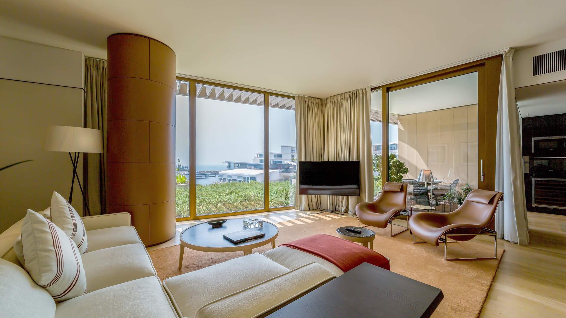 Luxurious living room in Jumeirah Bay Island apartment with modern decor and large windows