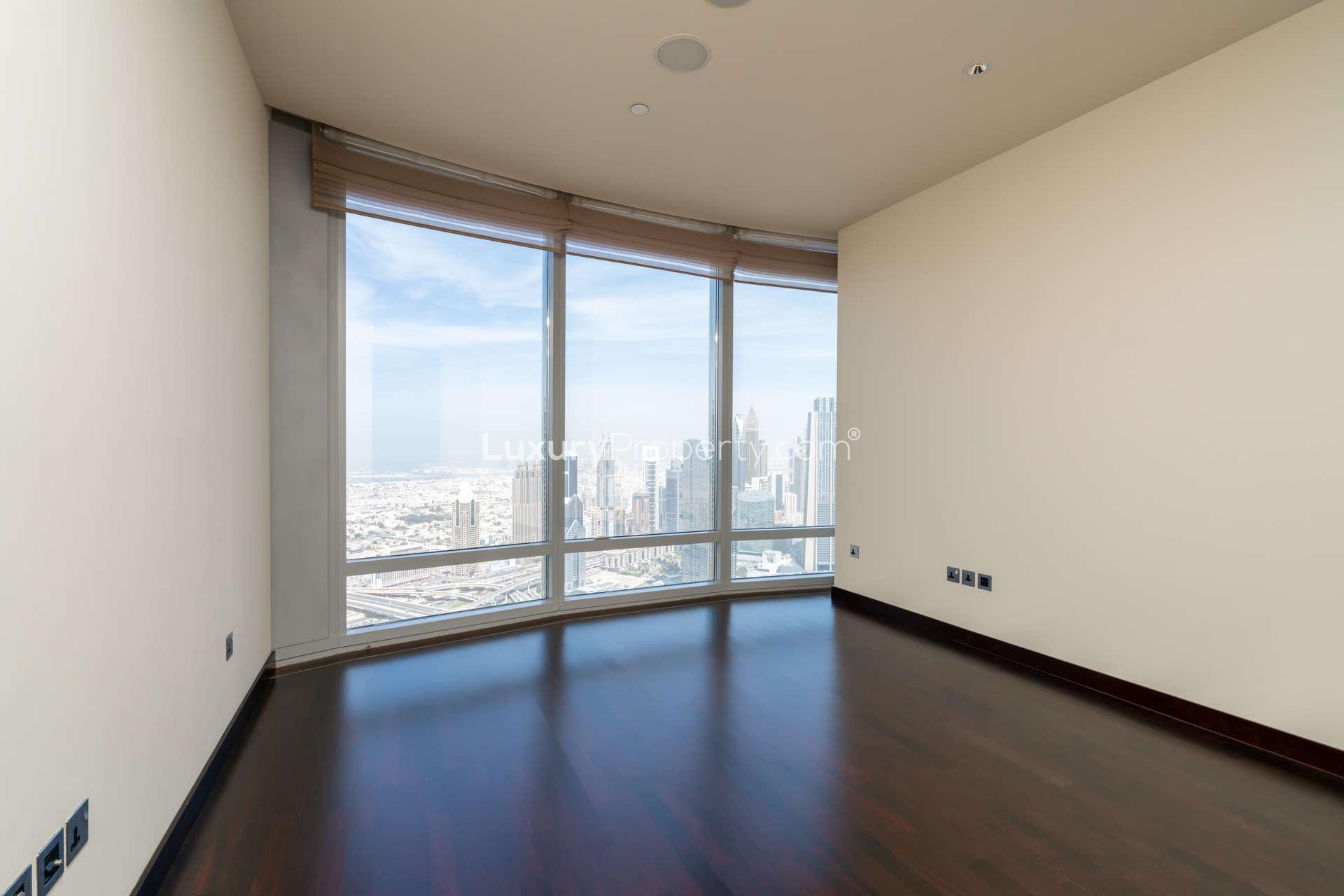 "Elegant hallway in Burj Khalifa Area apartment, Downtown Dubai, LP03912 for sale.",Empty room with large windows offering DIFC views in Burj Khalifa area apartment