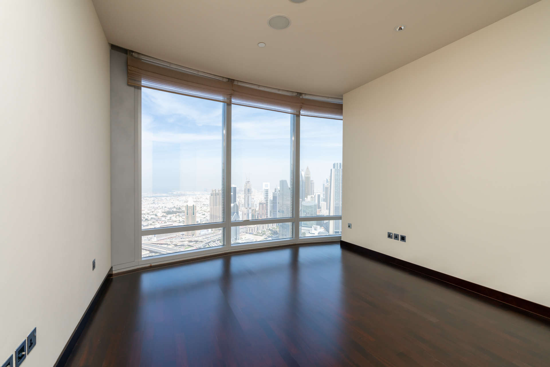 "Elegant hallway in Burj Khalifa Area apartment, Downtown Dubai, LP03912 for sale.",Empty room with large windows offering DIFC views in Burj Khalifa area apartment