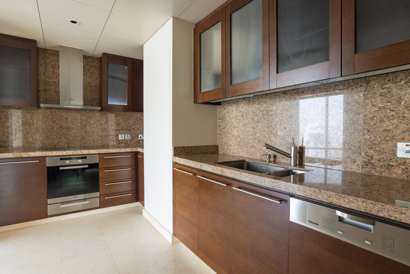 Modern kitchen in three-bedroom apartment, Burj Khalifa, Downtown Dubai, featuring sleek cabinetry and appliances