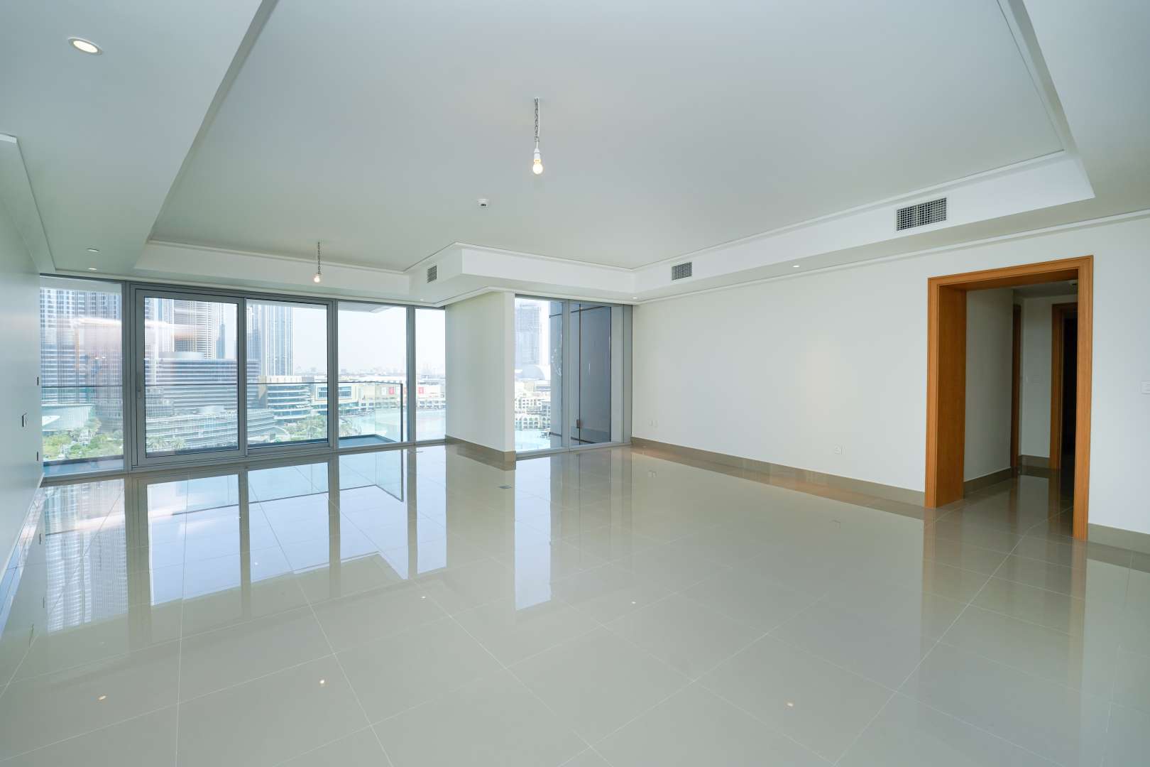 Empty bedroom with built-in wooden closet in Opera District apartment, Downtown Dubai