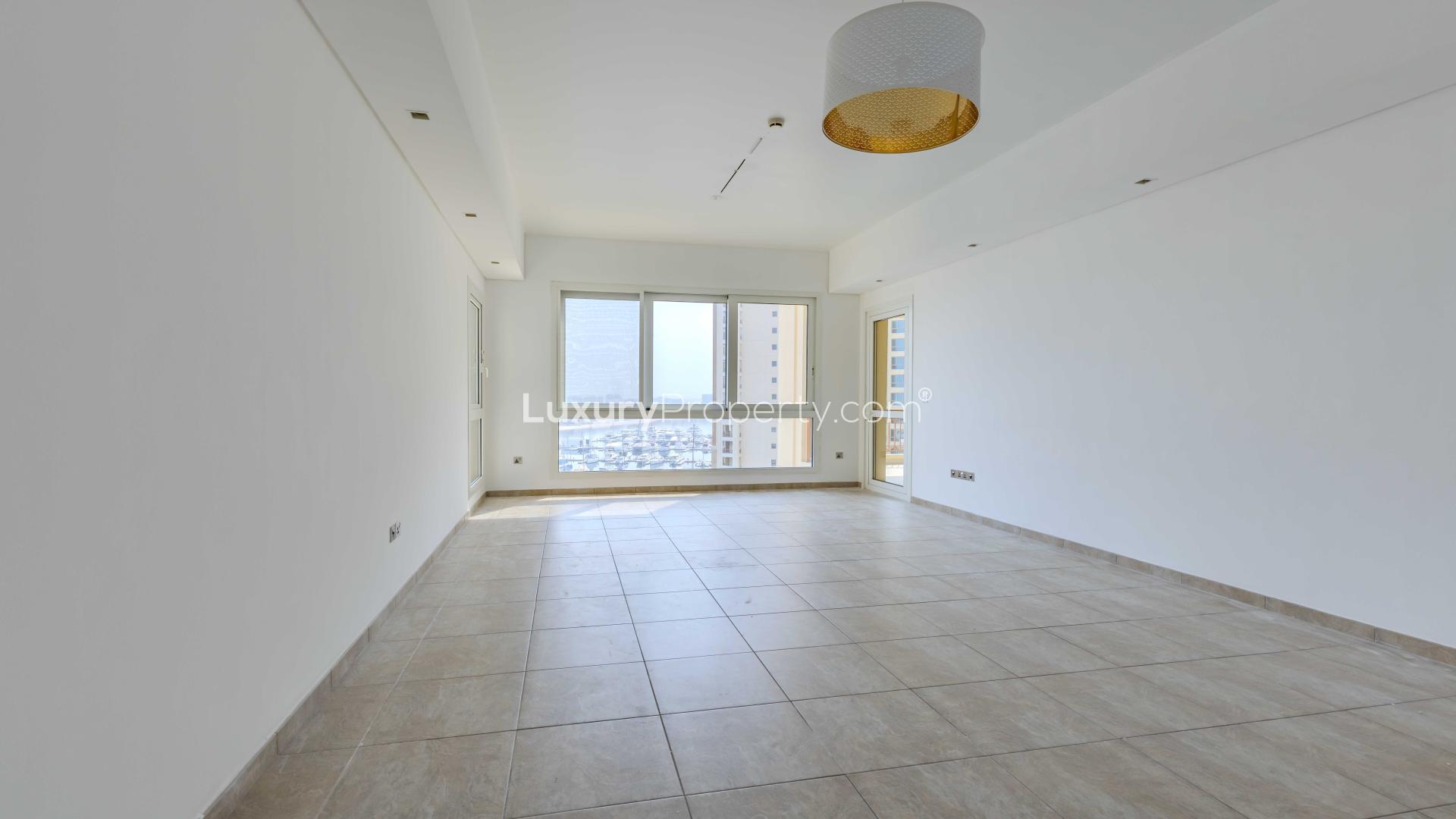 "Spacious empty room in Marina Residences 3-bedroom apartment, Palm Jumeirah for sale.",Bright living room in 3-bedroom apartment, Marina Residences, Palm Jumeirah for sale