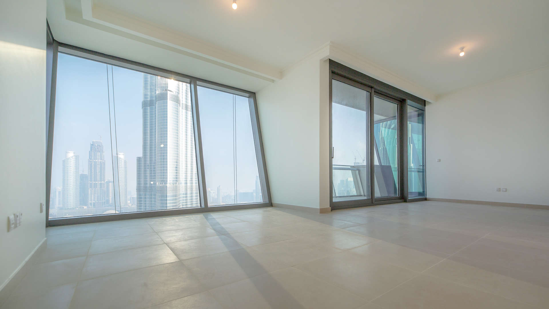 Luxurious Burj Vista apartment interior with floor-to-ceiling windows and stunning Downtown Dubai views