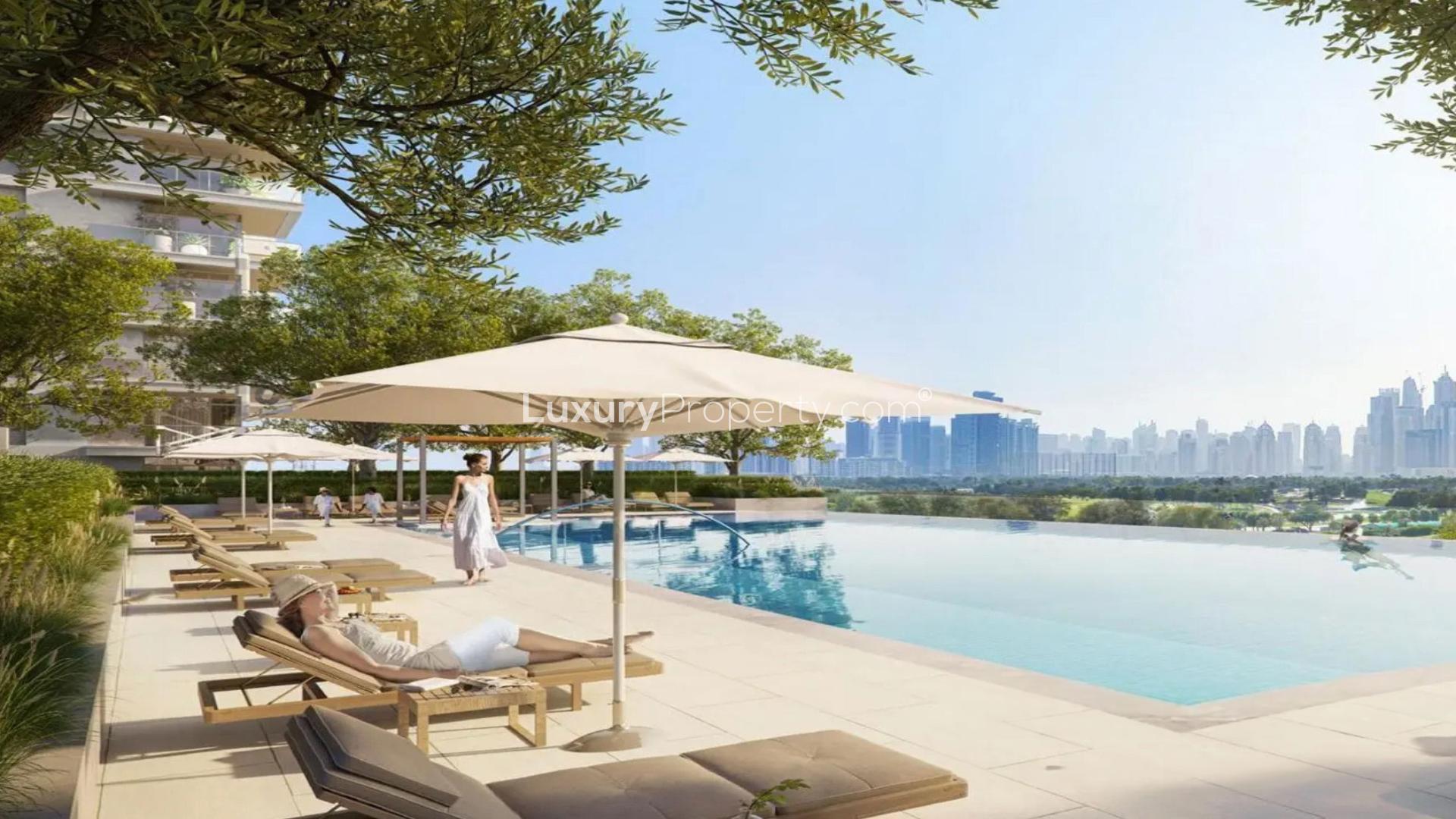 Exterior view of Golf Heights apartment with balcony overlooking Emirates Hills skyline and golf course