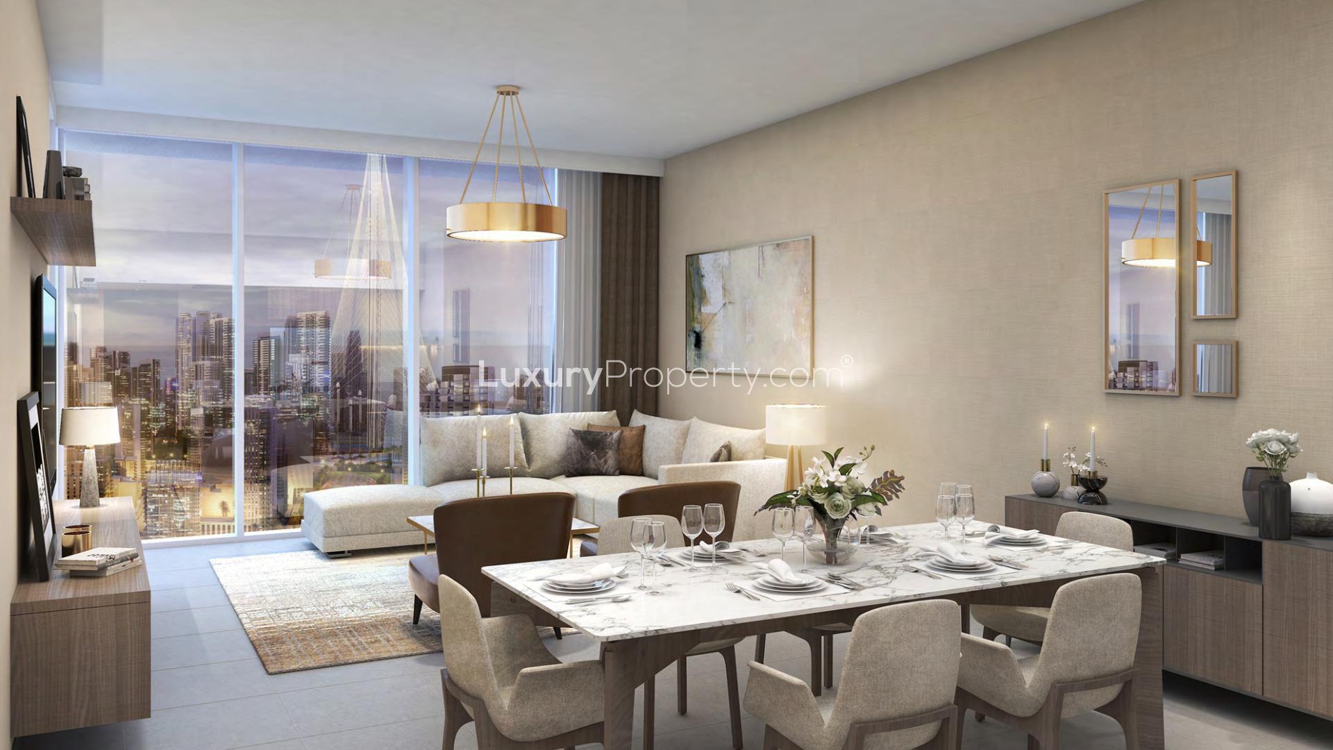 Aerial view of Creek Gate apartments with waterfront and cityscape at night