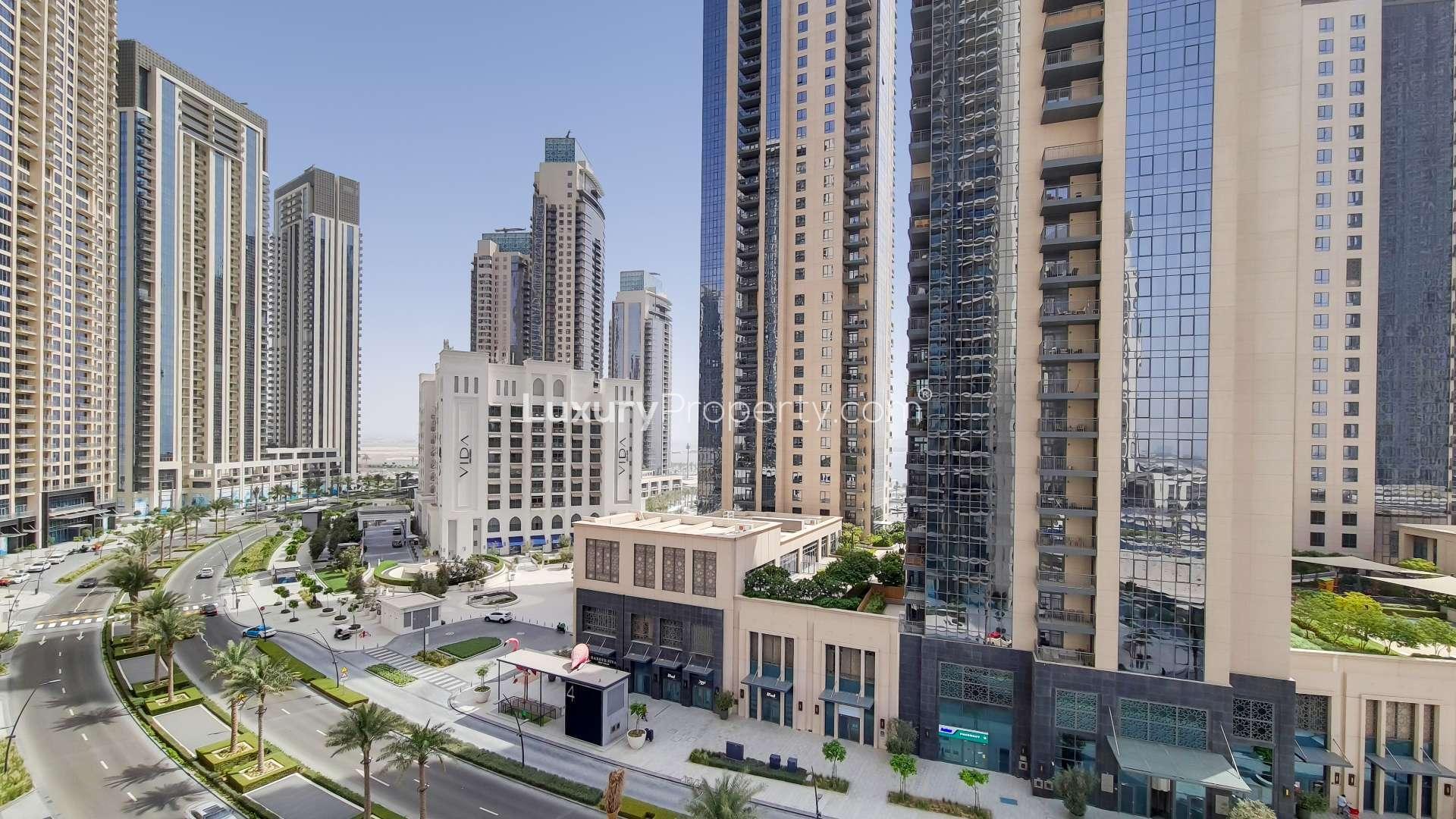 Modern living room in Creek Horizon apartment, Dubai Creek Harbour, with city view