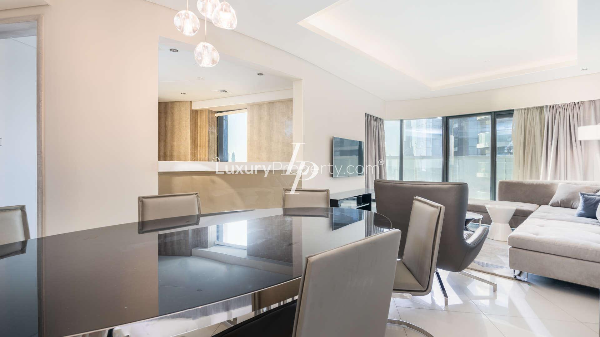 "Spacious bedroom in luxury Business Bay apartment with stunning sea views and modern decor.",Luxury 3-bedroom apartment interior with modern dining and living area in Business Bay