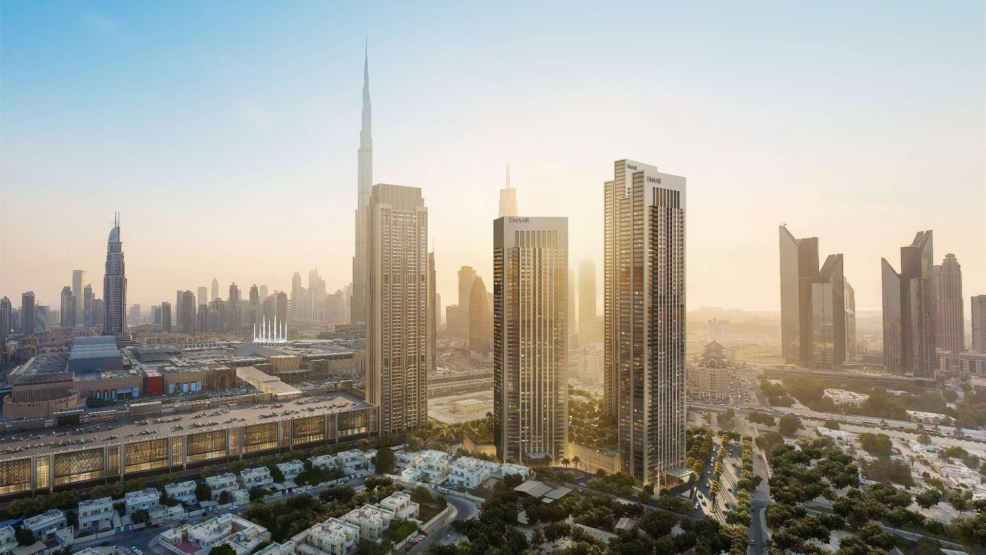 "Stunning view from Downtown Dubai apartment overlooking Burj Khalifa and city skyline at sunset.",Modern kitchen in 3-bedroom Downtown Dubai apartment with Burj Khalifa views, for sale