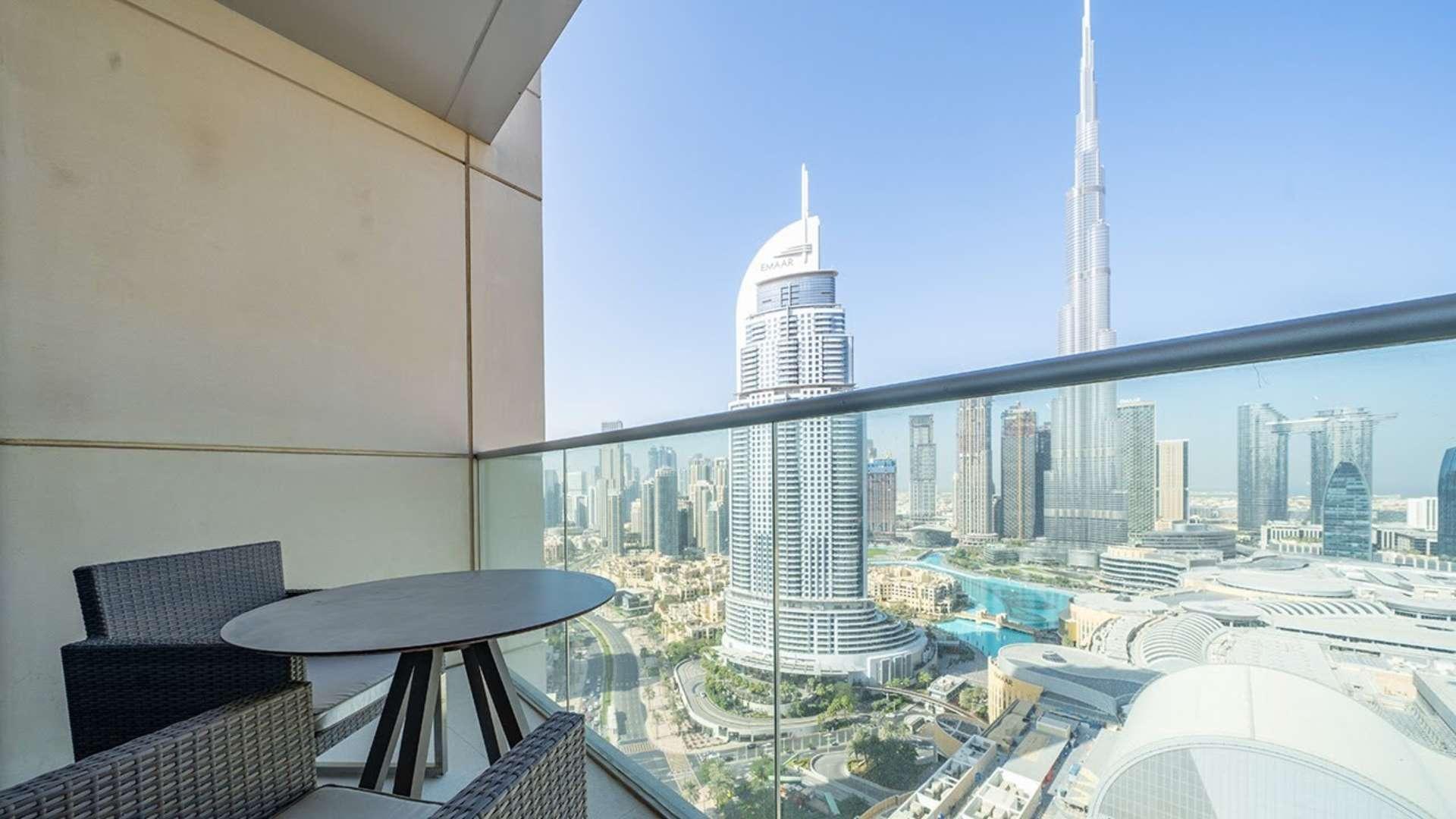 Modern kitchen in Downtown Dubai apartment with Burj Khalifa view, sleek design, natural light