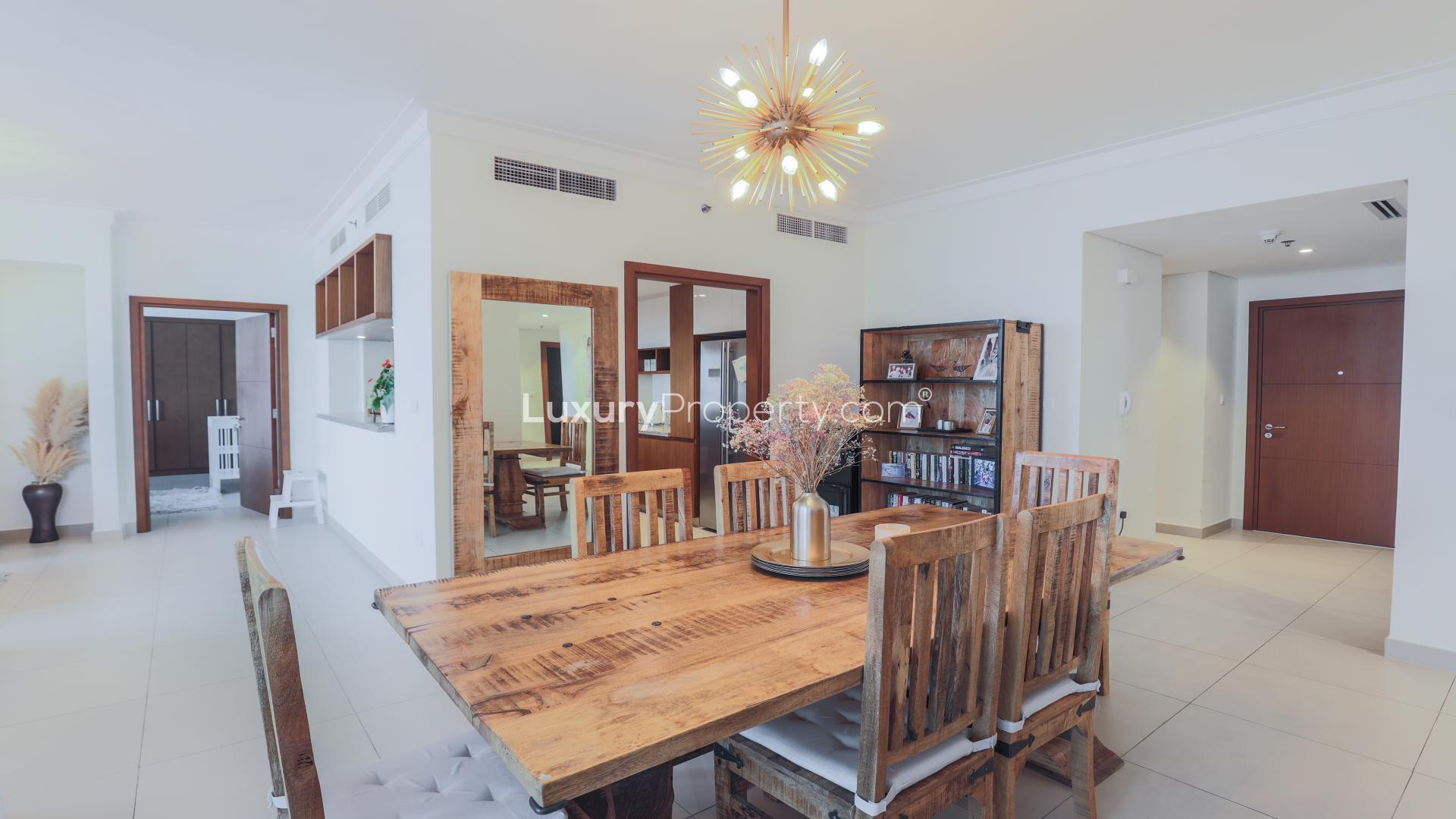 "Spacious dining area in 3-bedroom apartment, Dubai Creek Harbour, elegant decor and natural light.",Dining area in 3-bedroom apartment at Dubai Creek Harbour, modern decor and wooden furniture