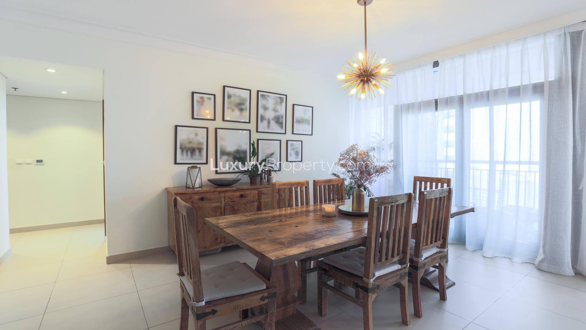 Dining area in 3-bedroom apartment, Dubai Creek Harbour, with elegant decor and wooden furniture