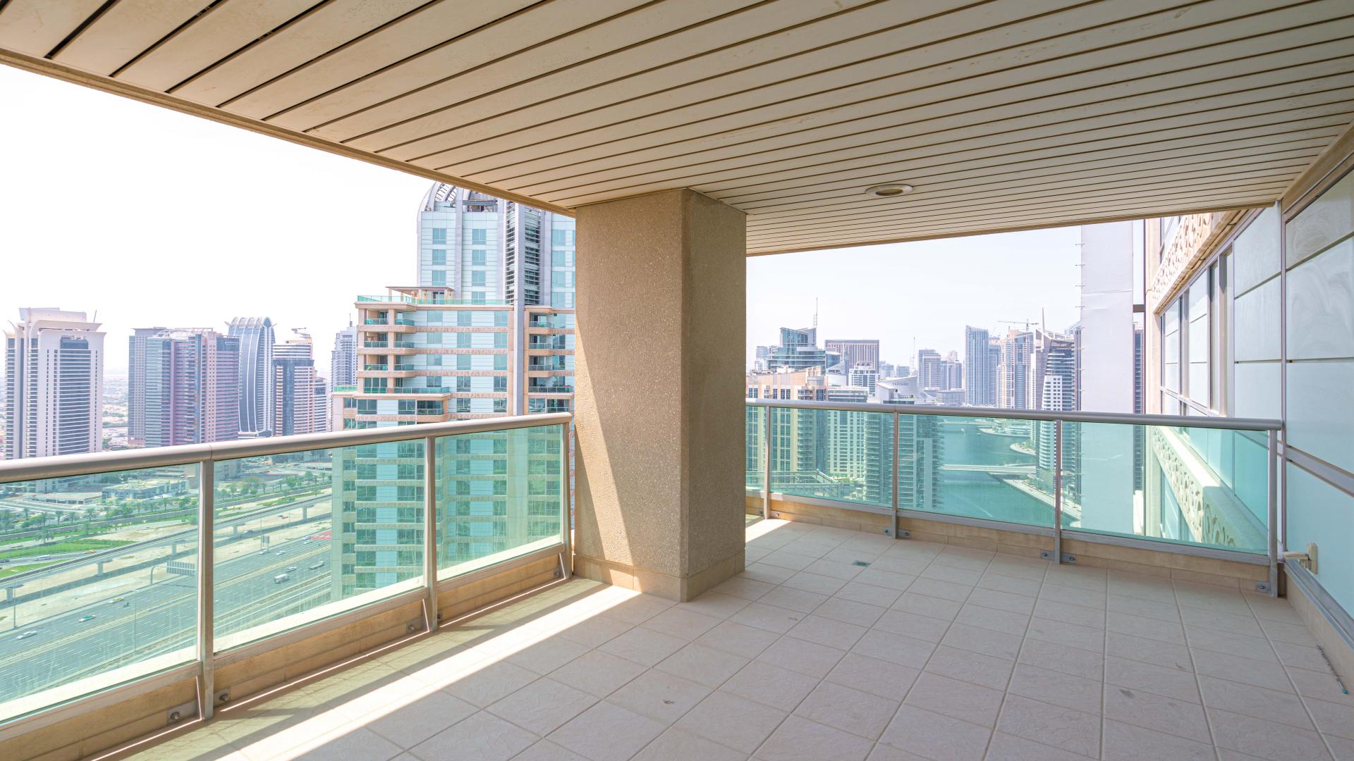 Spacious living room with large windows in Emaar 6 Towers, Dubai Marina apartment for sale