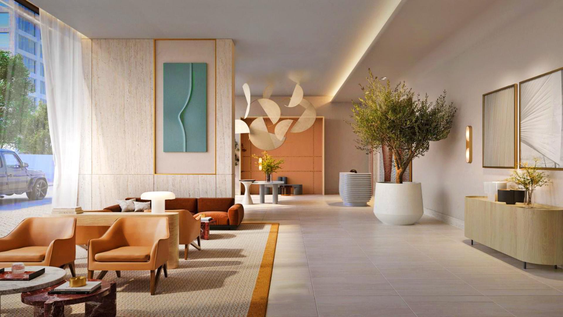 Woman enjoying stunning sea view from large family apartment in Emaar Beachfront, Dubai Harbour