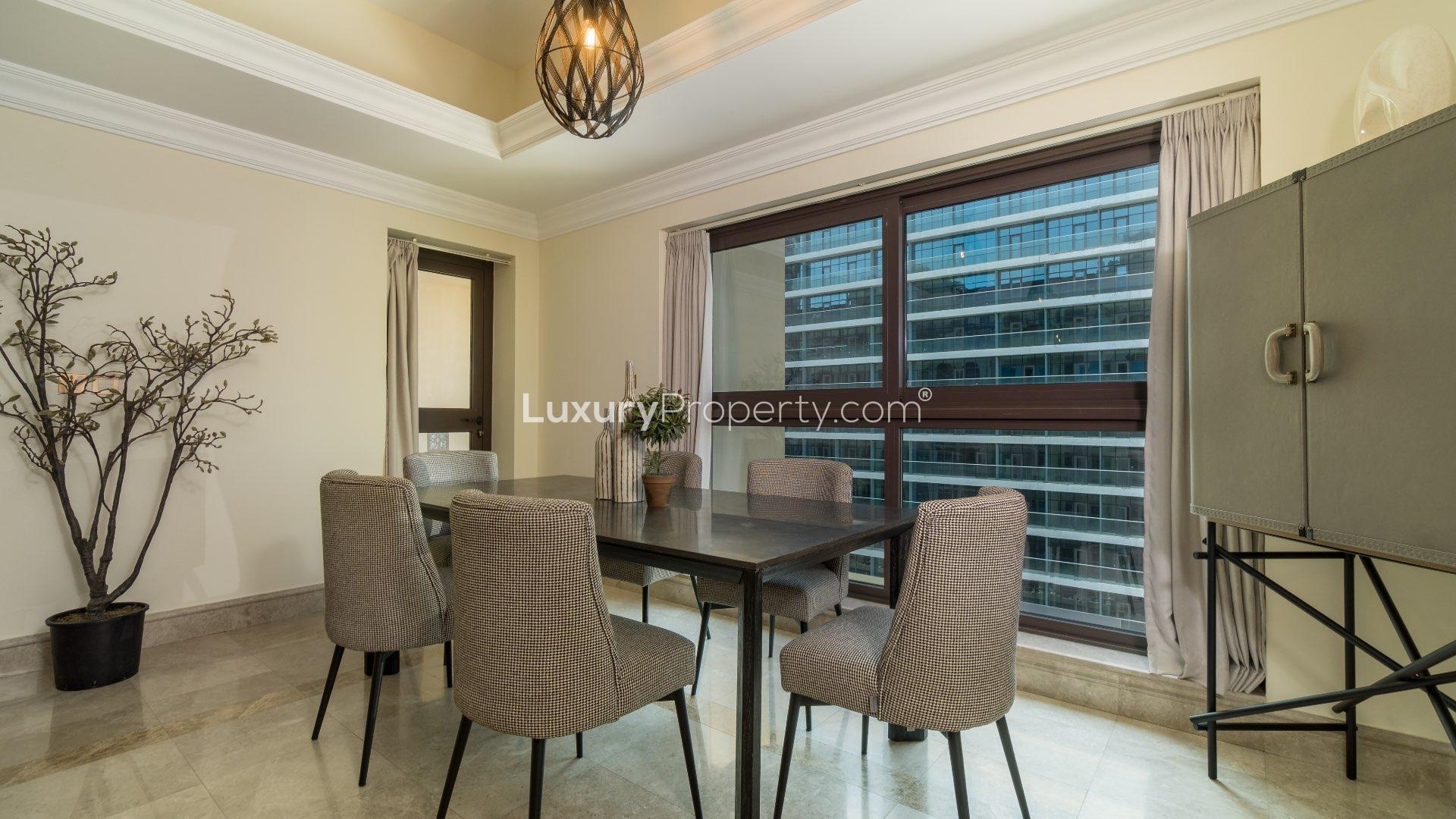 Modern kitchen and hallway in Fairmont Residences apartment, Palm Jumeirah. Spacious layout
