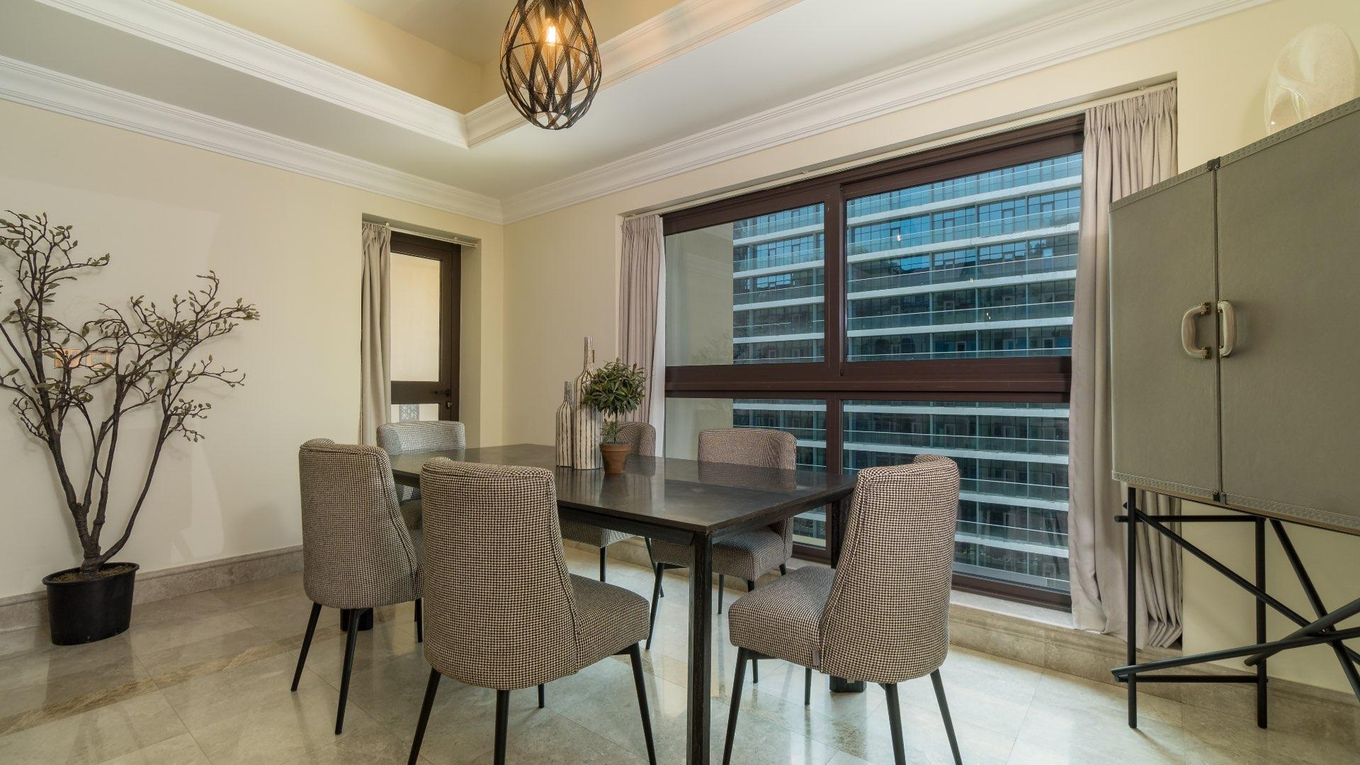 Modern kitchen and hallway in Fairmont Residences apartment, Palm Jumeirah. Spacious layout
