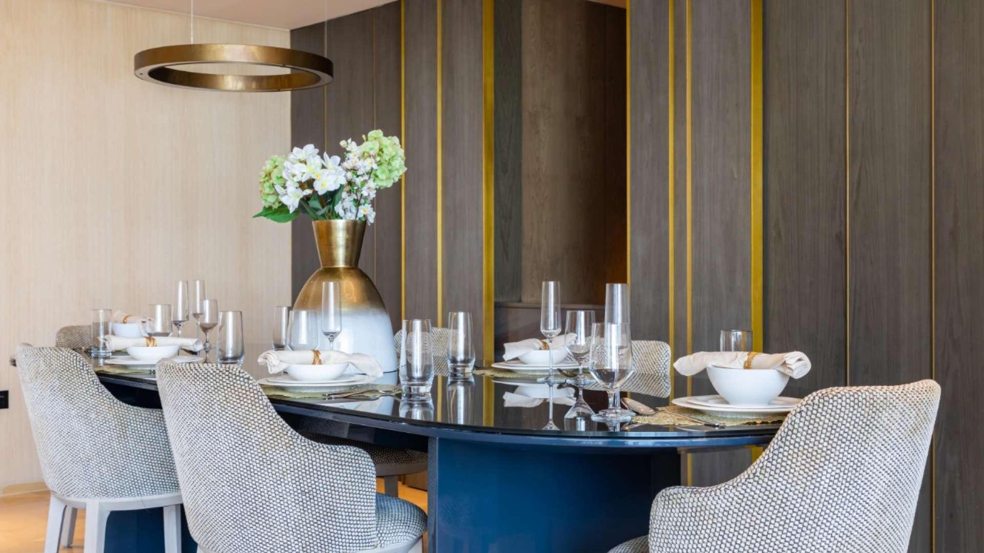 Fully furnished dining and living area in Palm Jumeirah apartment, modern decor, elegant lighting