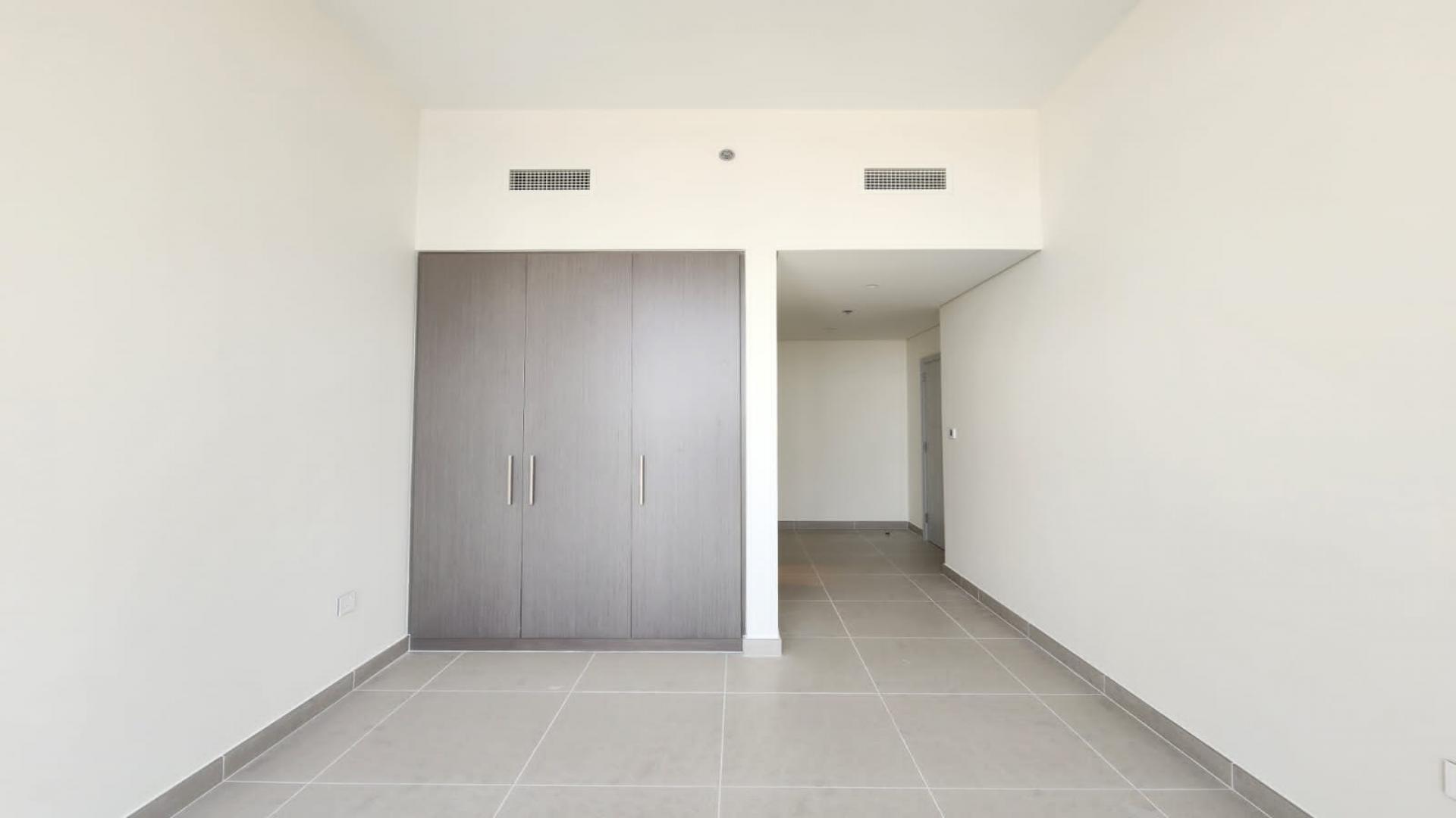 "Bright room with large window view in Downtown Dubai apartment for sale, Forte community.",Modern bedroom with built-in wardrobe in 3-bedroom apartment, Downtown Dubai, Forte community