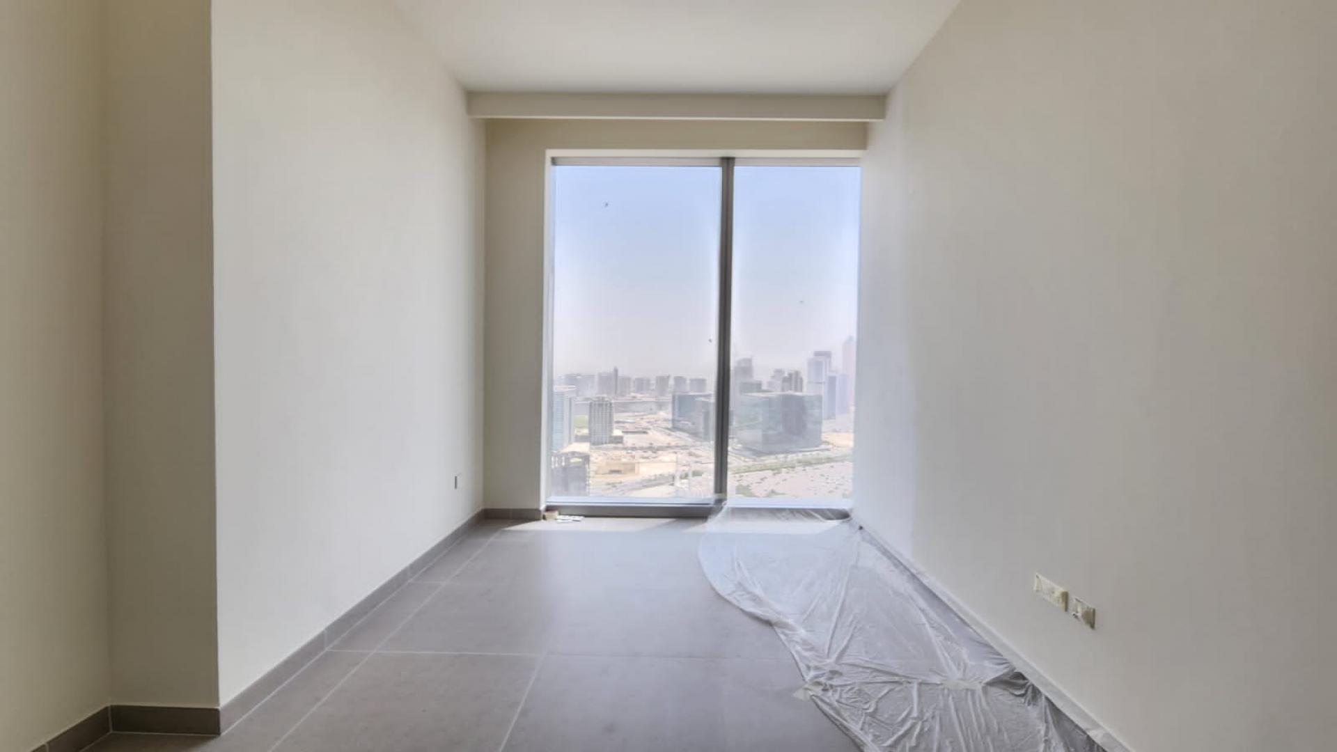 Empty room with tiled floor and built-in wardrobe in Downtown Dubai apartment for sale