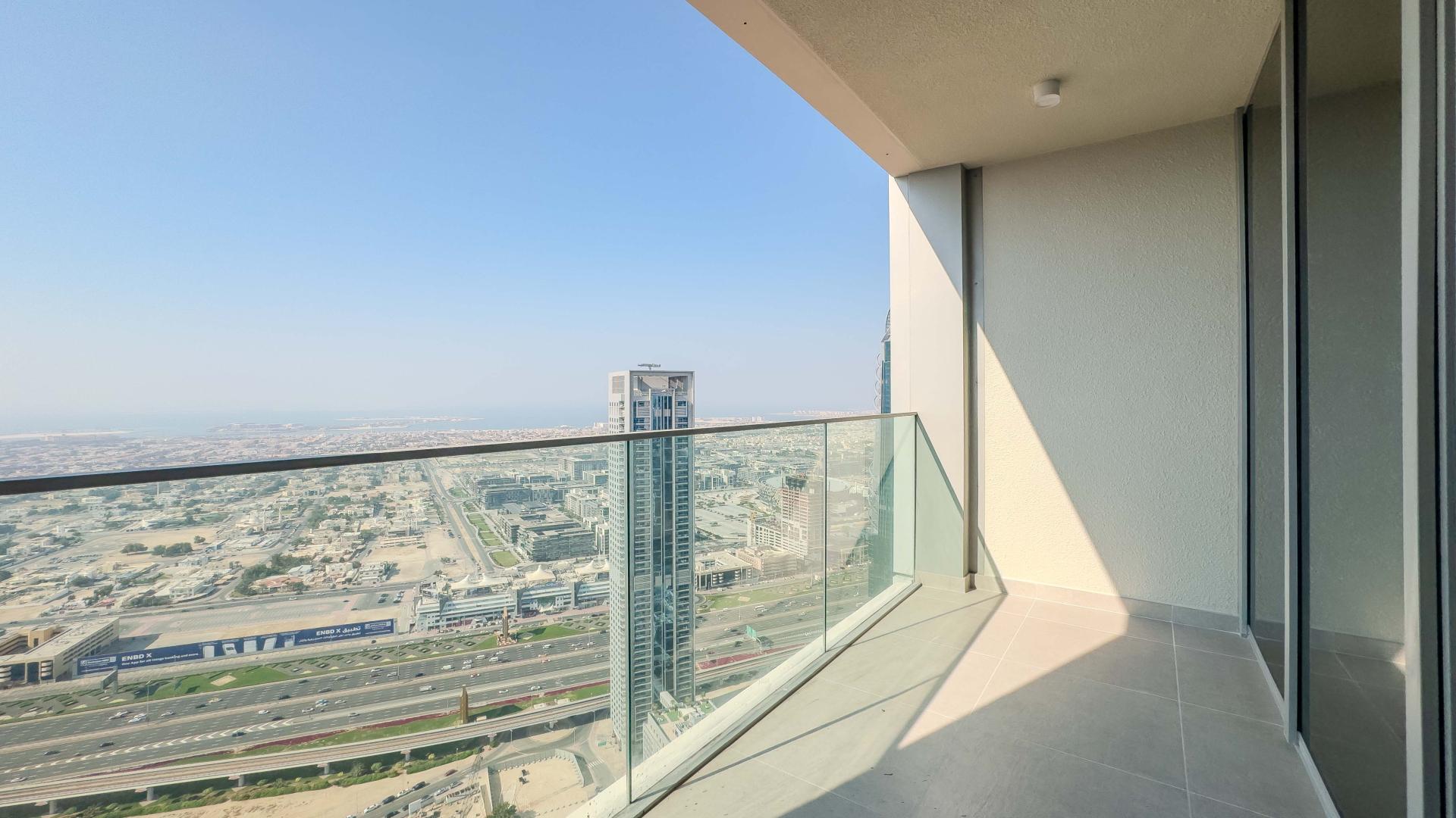 Empty bedroom with open door and built-in wardrobe in Forte, Downtown Dubai apartment