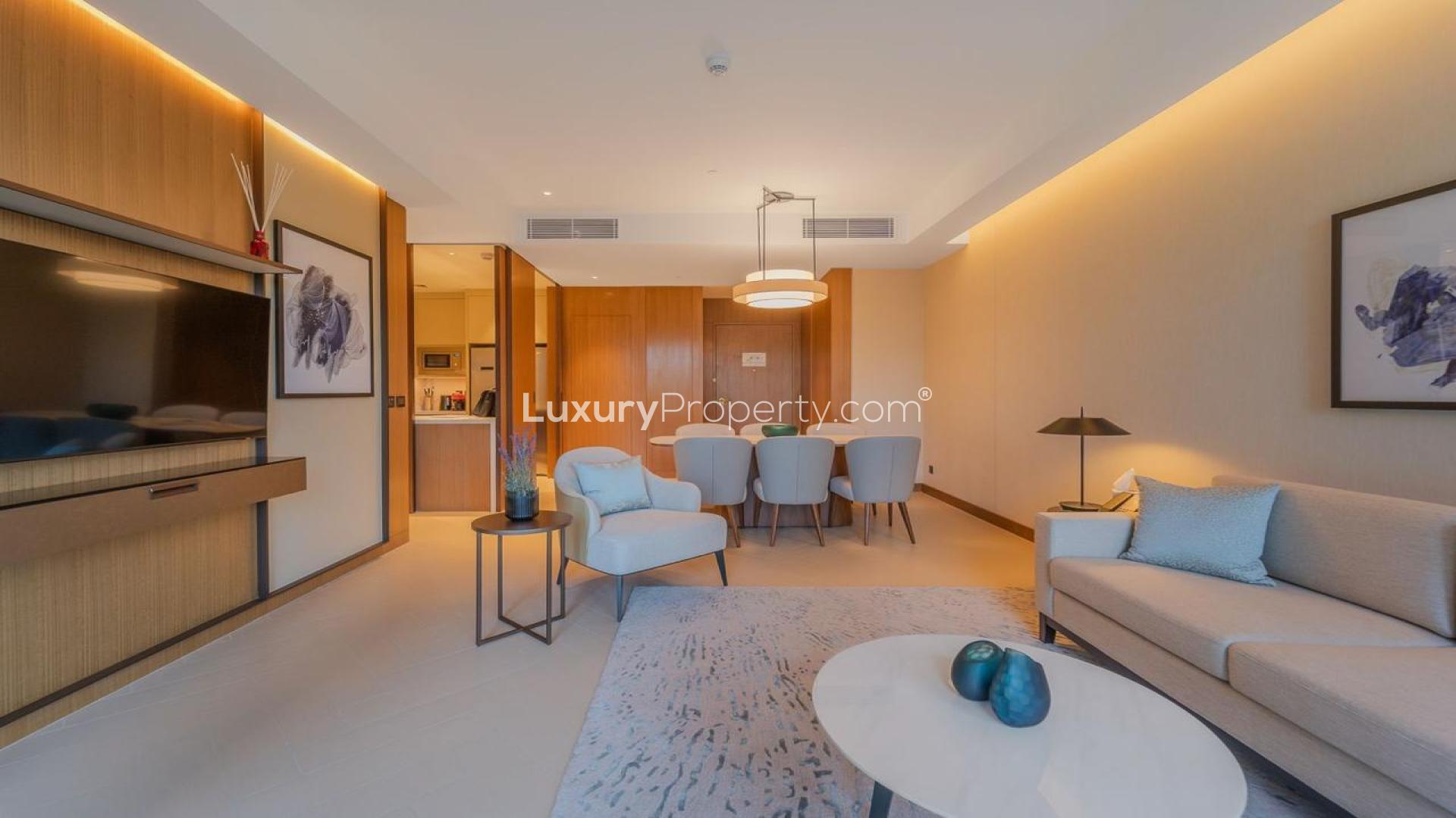 "Stunning view from Address Residences apartment balcony, overlooking Downtown Dubai skyline and greenery.",Furnished living room in Address Residences apartment, Downtown Dubai, with elegant decor and dining area