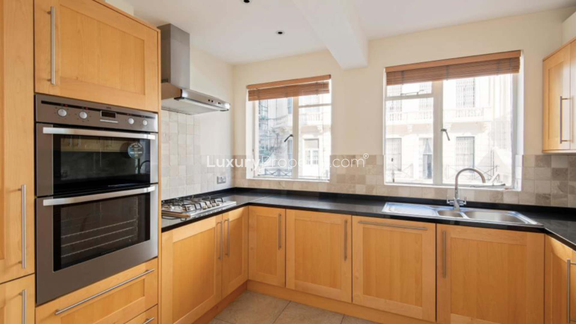 Elegant Knightsbridge apartment interior with large windows and wooden flooring, London
