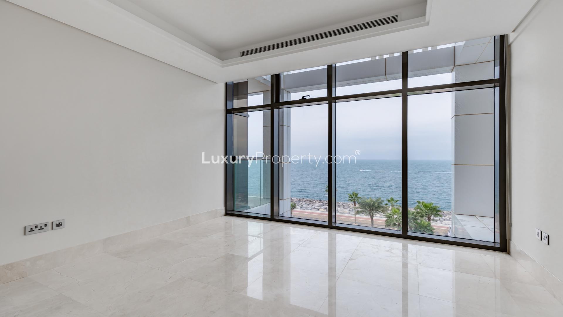 "Bright seafront apartment living room with ocean view at 8 on Palm Jumeirah, Dubai.",Seafront balcony view from 3-bedroom apartment at 8 on Palm Jumeirah, The Crescent