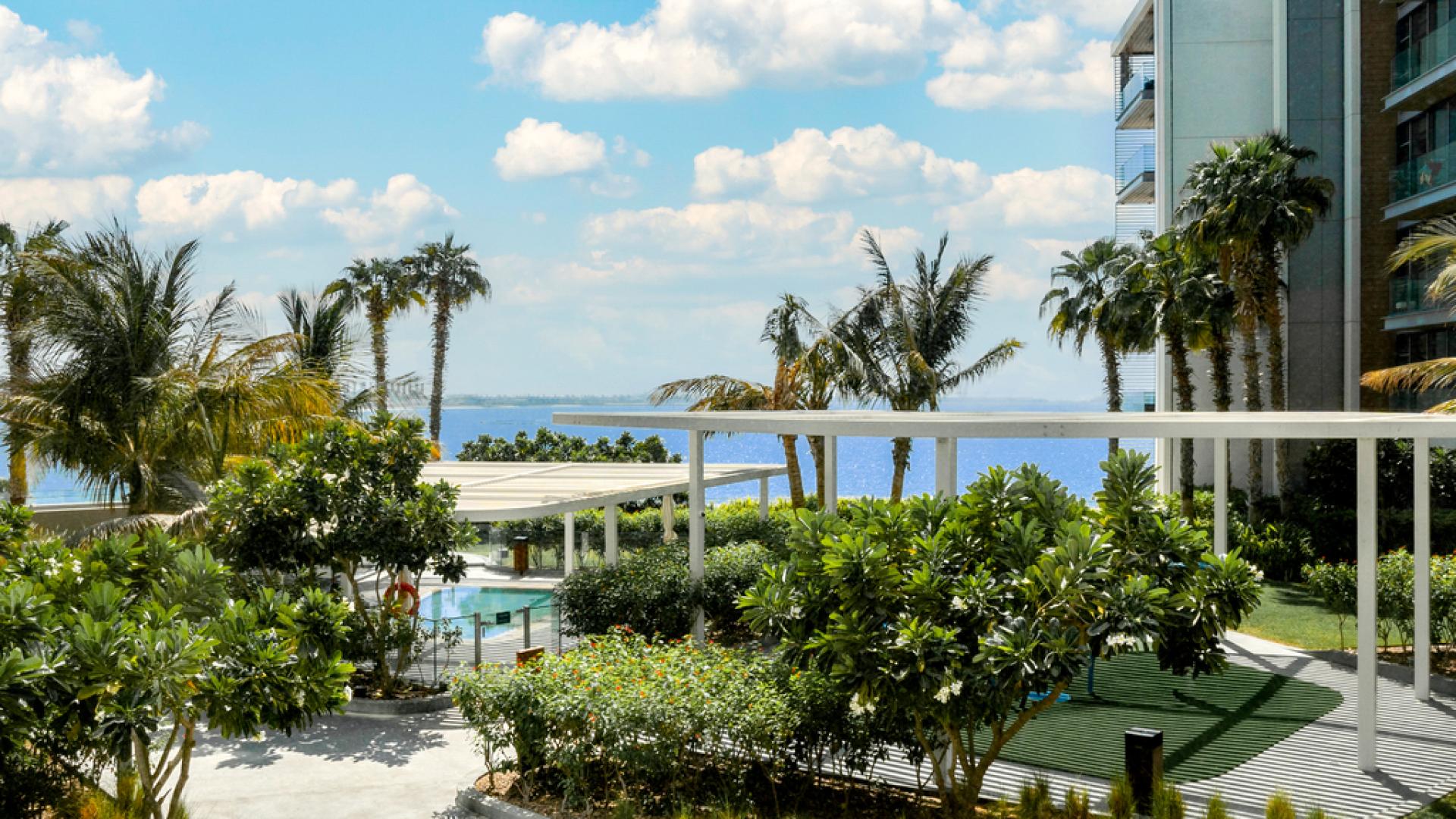 Luxurious living room in upgraded Bluewaters 3-bedroom apartment with modern decor and large windows