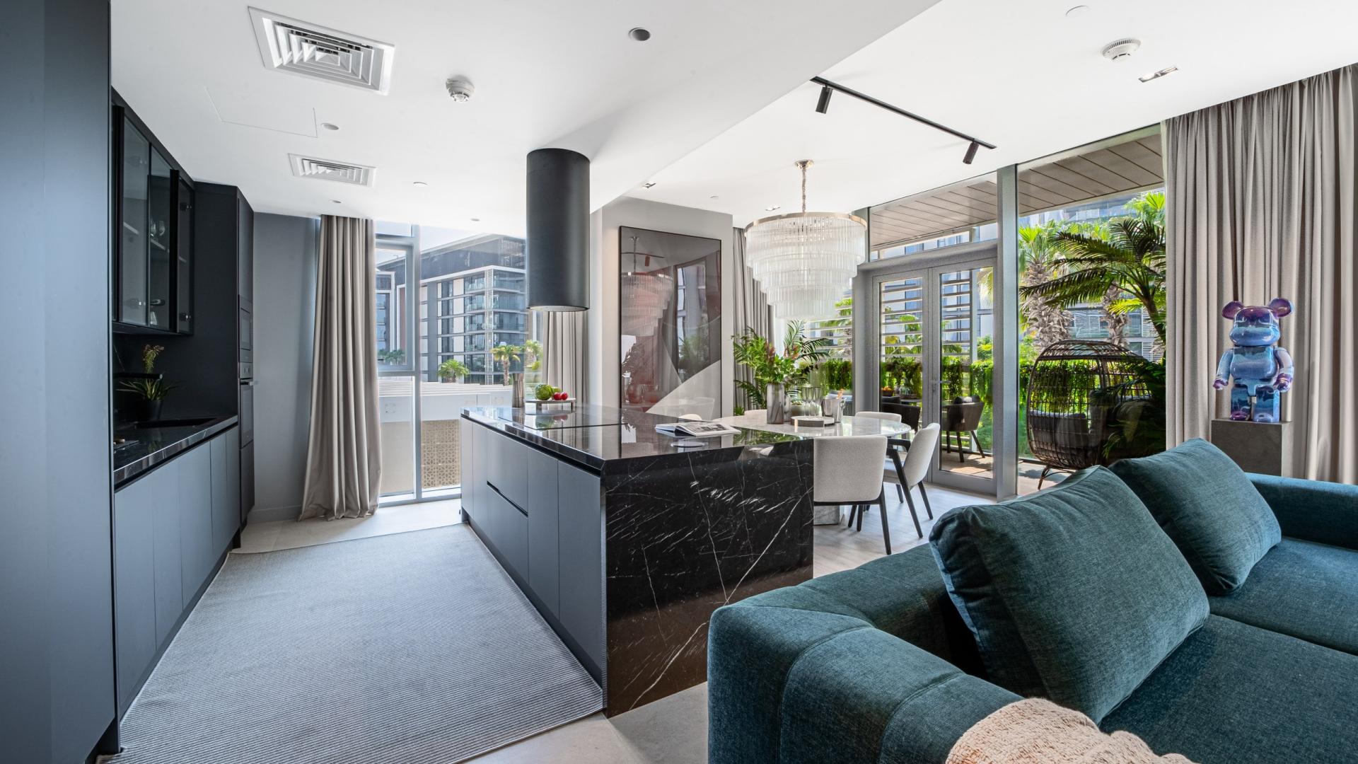 Modern living room in 3-bedroom Bluewaters Residences apartment, featuring stylish decor and large windows