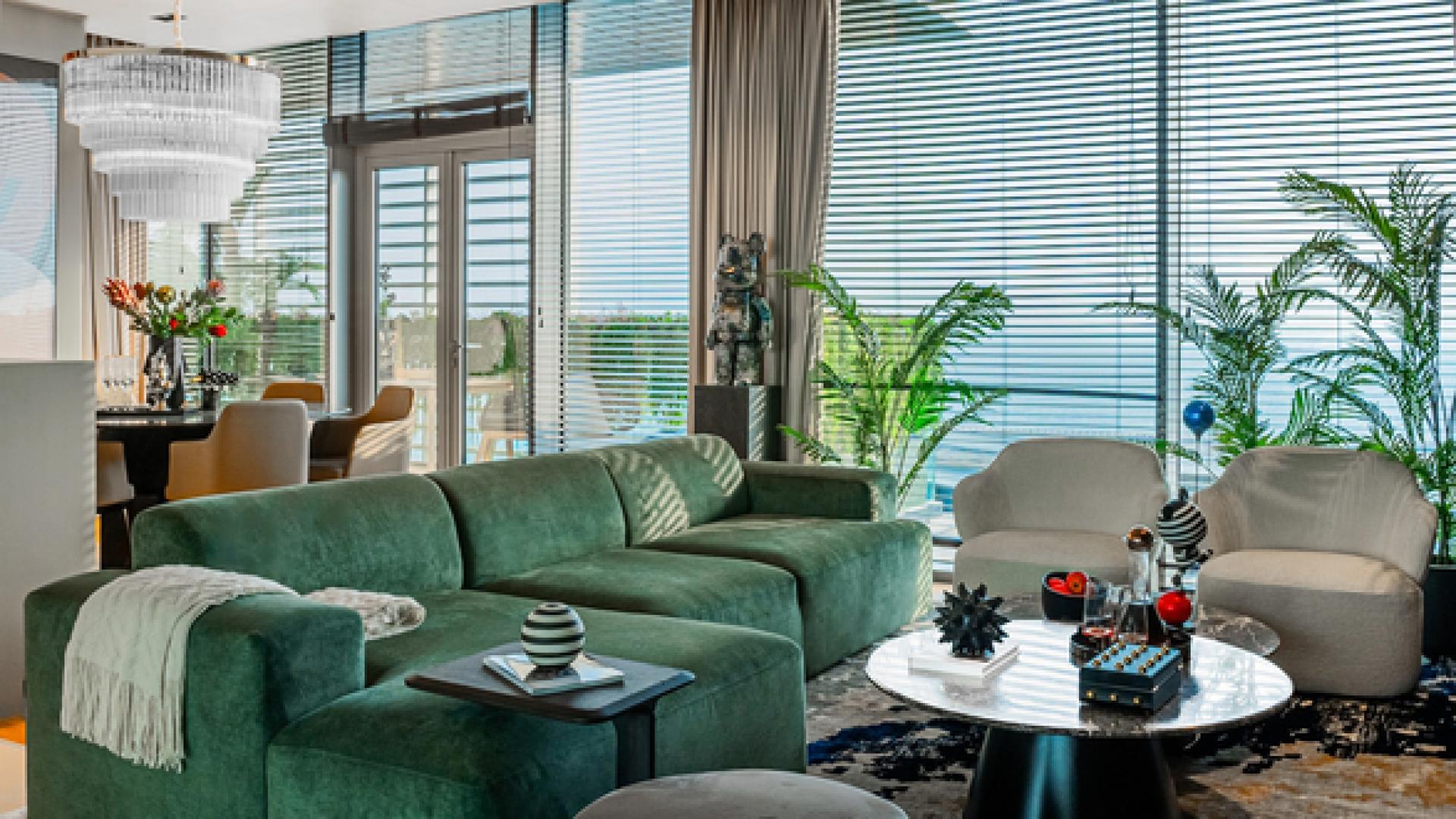 "Bluewaters Dubai apartment with stunning sea and park views, lush greenery, modern architecture.",Luxurious living room with sea views in Bluewaters Dubai apartment for sale