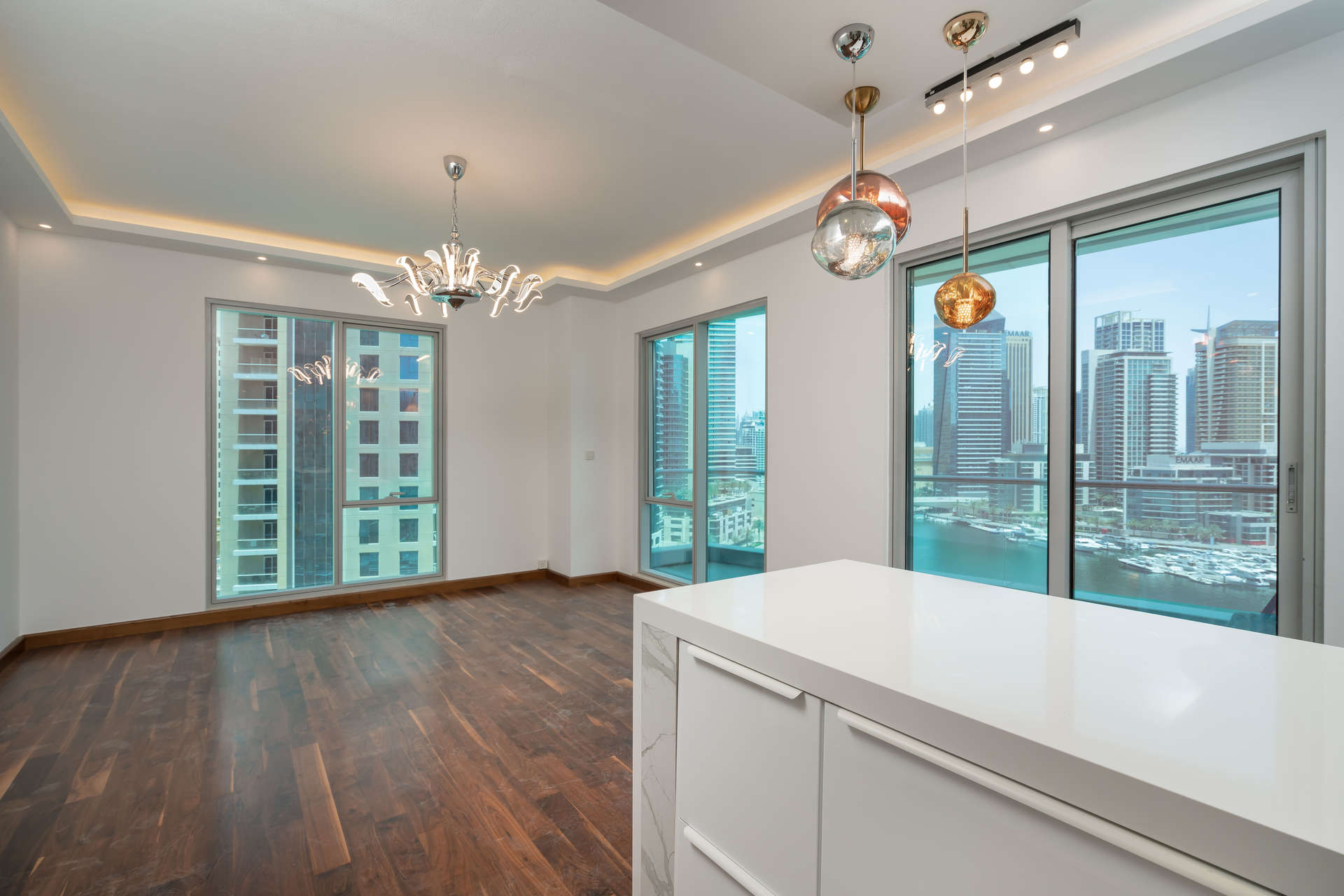 Modern kitchen with stylish lighting and marina views in Delphine apartment, Dubai Marina