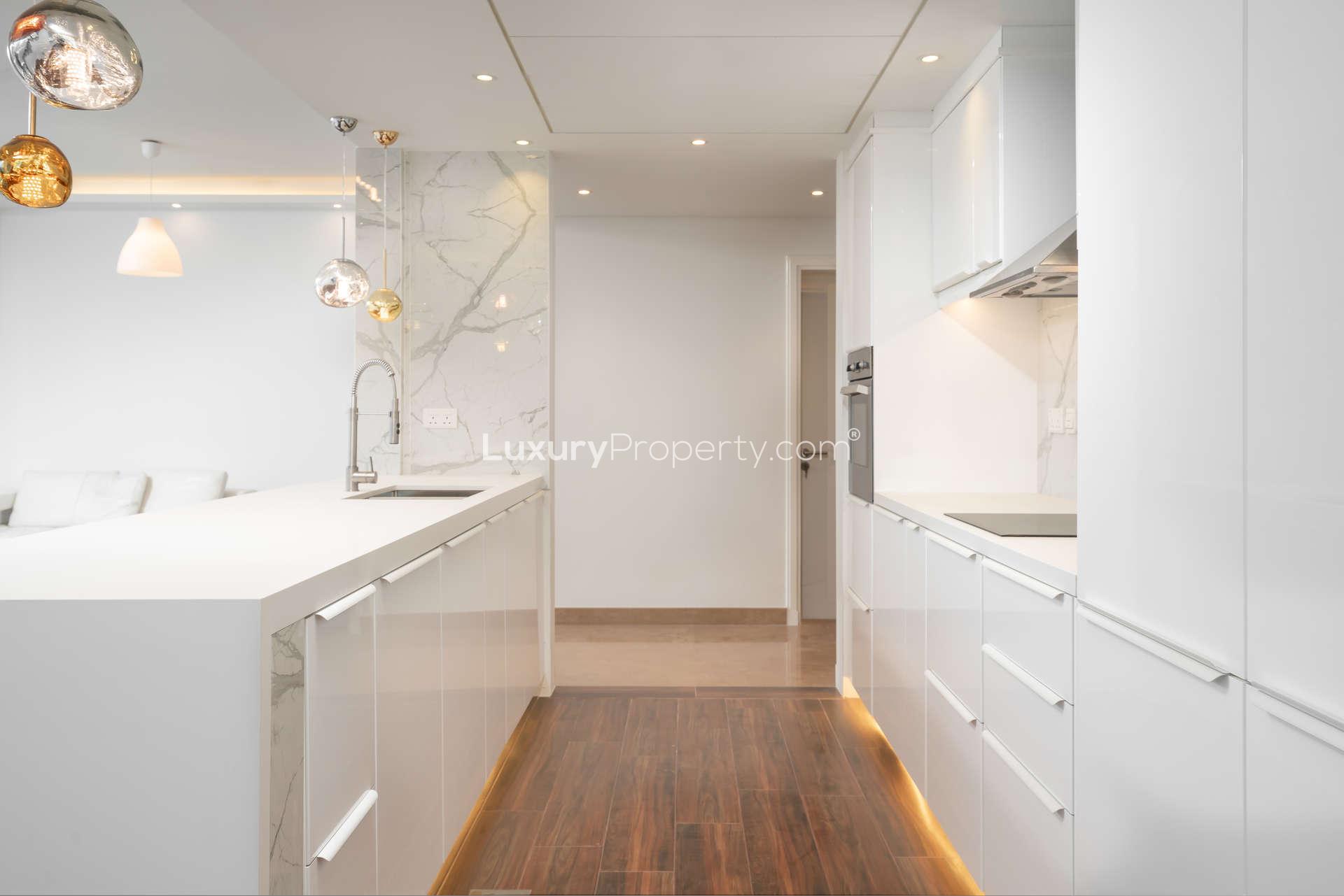 Elegant living room with modern lighting and marina views in Delphine apartment, Dubai Marina