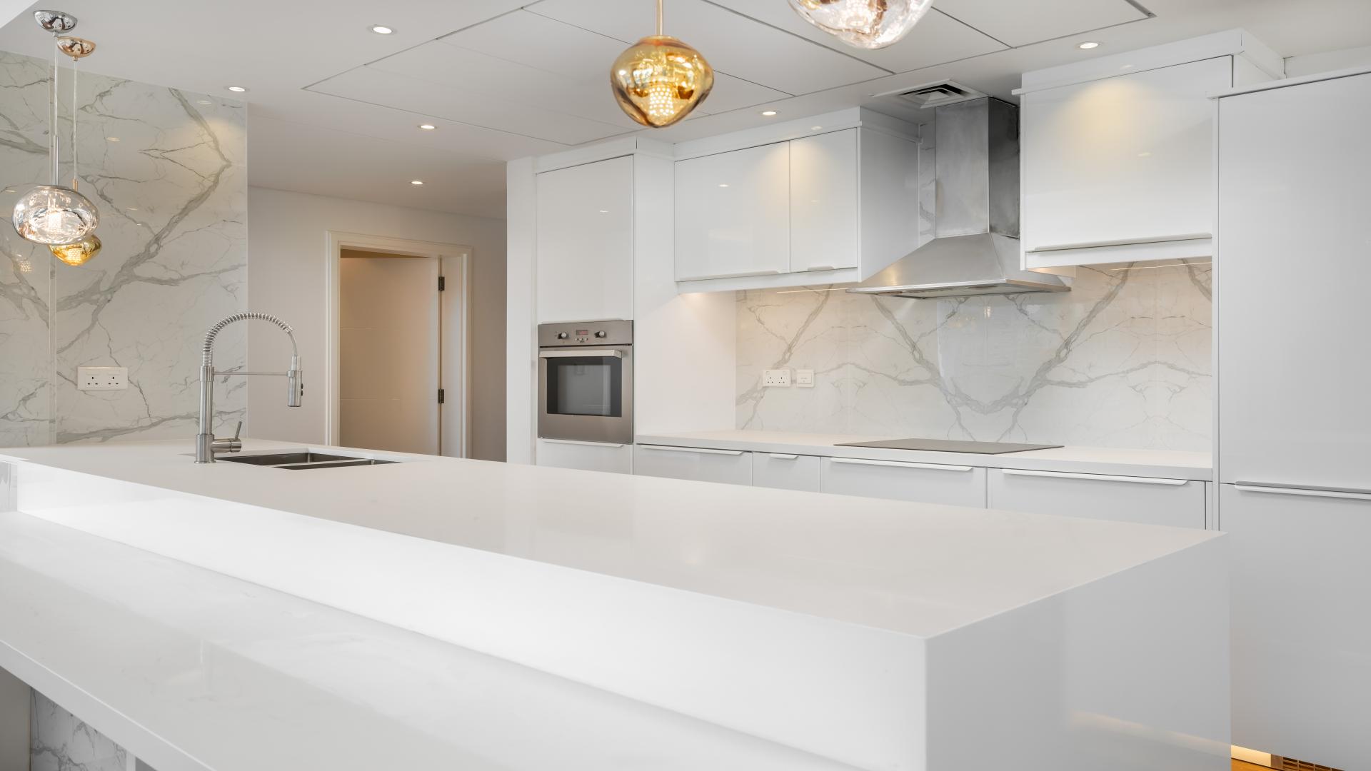 "Spacious upgraded apartment interior with marina views in Dubai Marina, Marina Promenade.",Modern kitchen in fully upgraded 3-bedroom apartment, Dubai Marina, marble countertops, sleek design