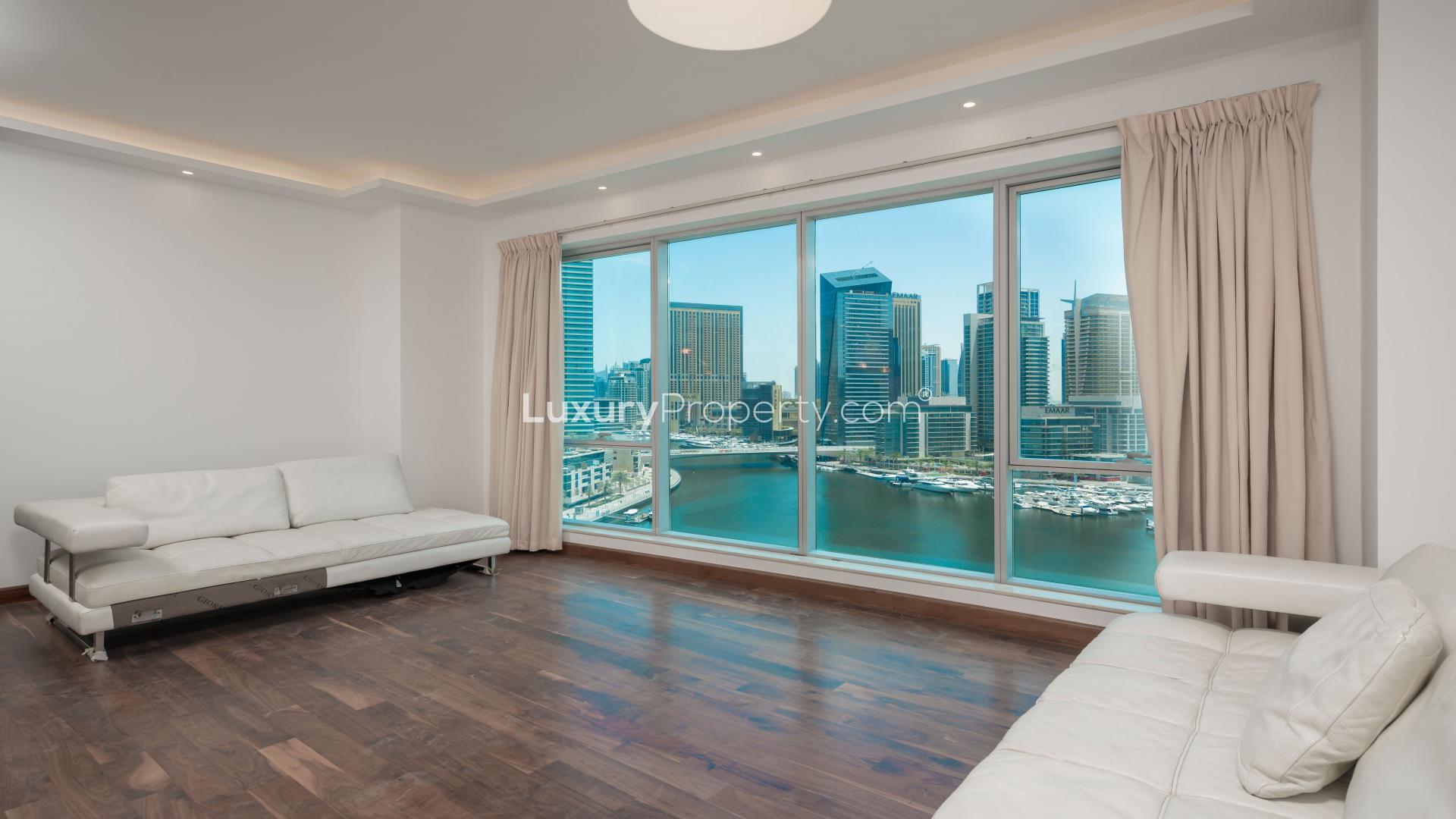 Bright living room with Marina views in upgraded Dubai Marina apartment for sale