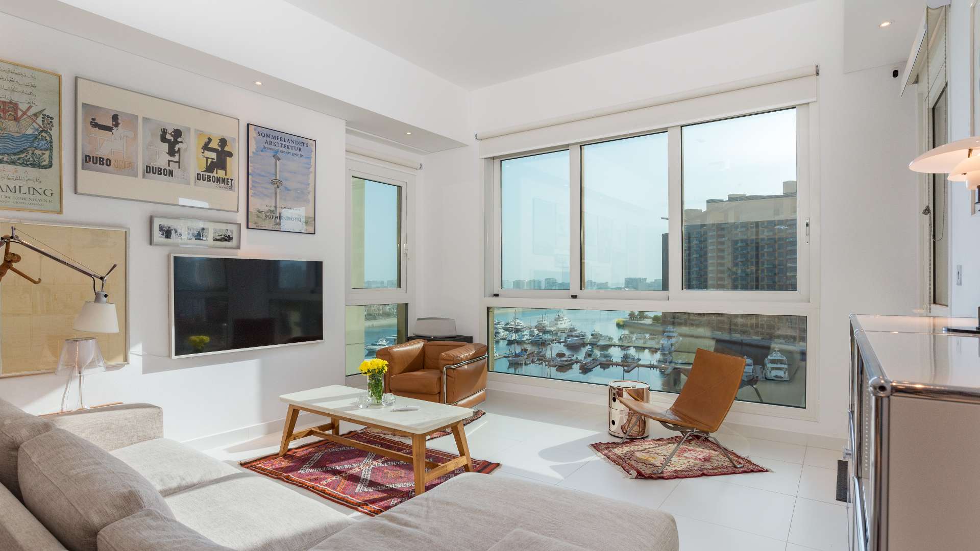Bright living room in Palm Jumeirah apartment with sea view, modern decor, and large windows