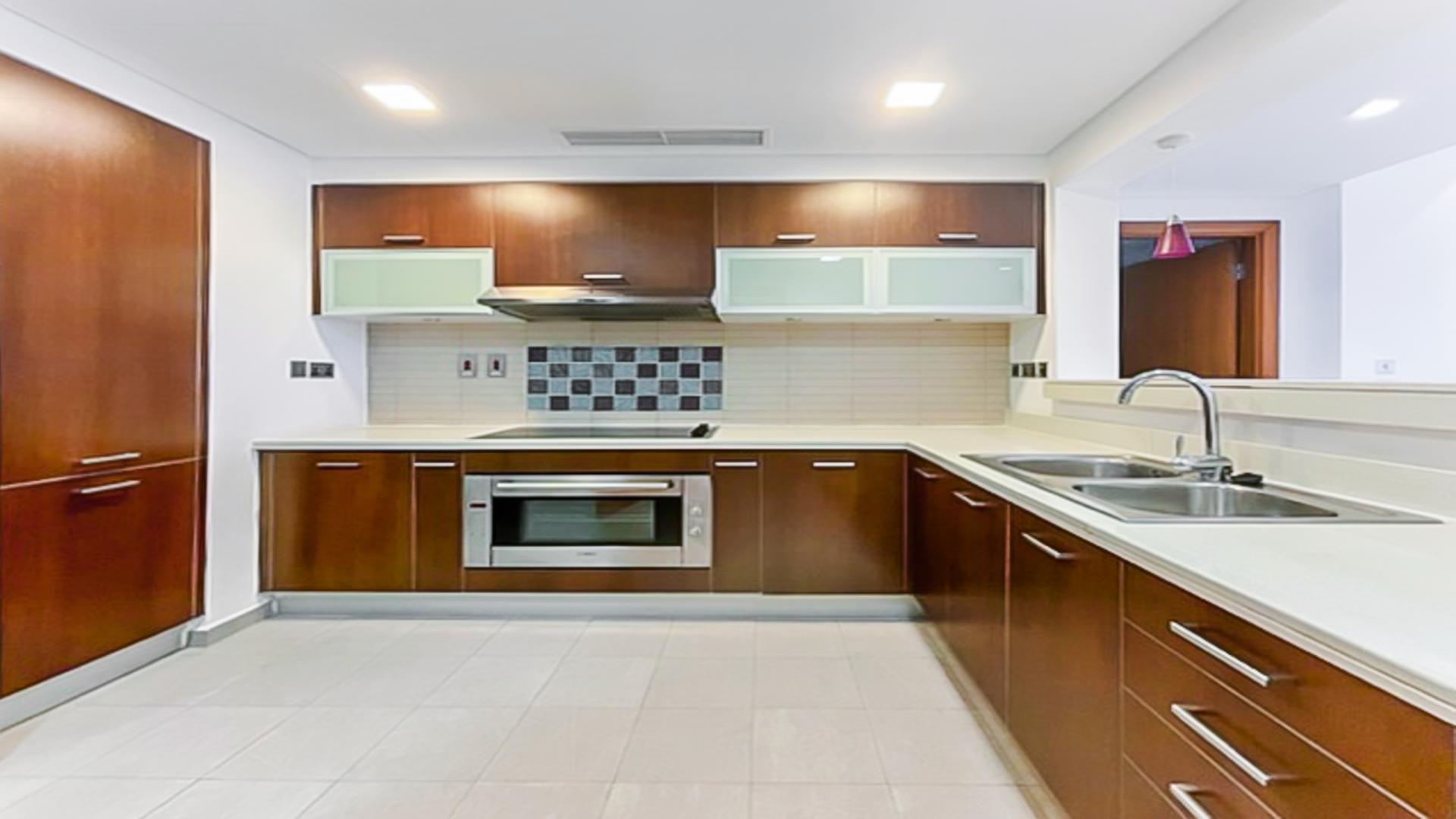 Modern kitchen in Palm Jumeirah apartment, featuring sleek cabinetry and spacious countertops for sale