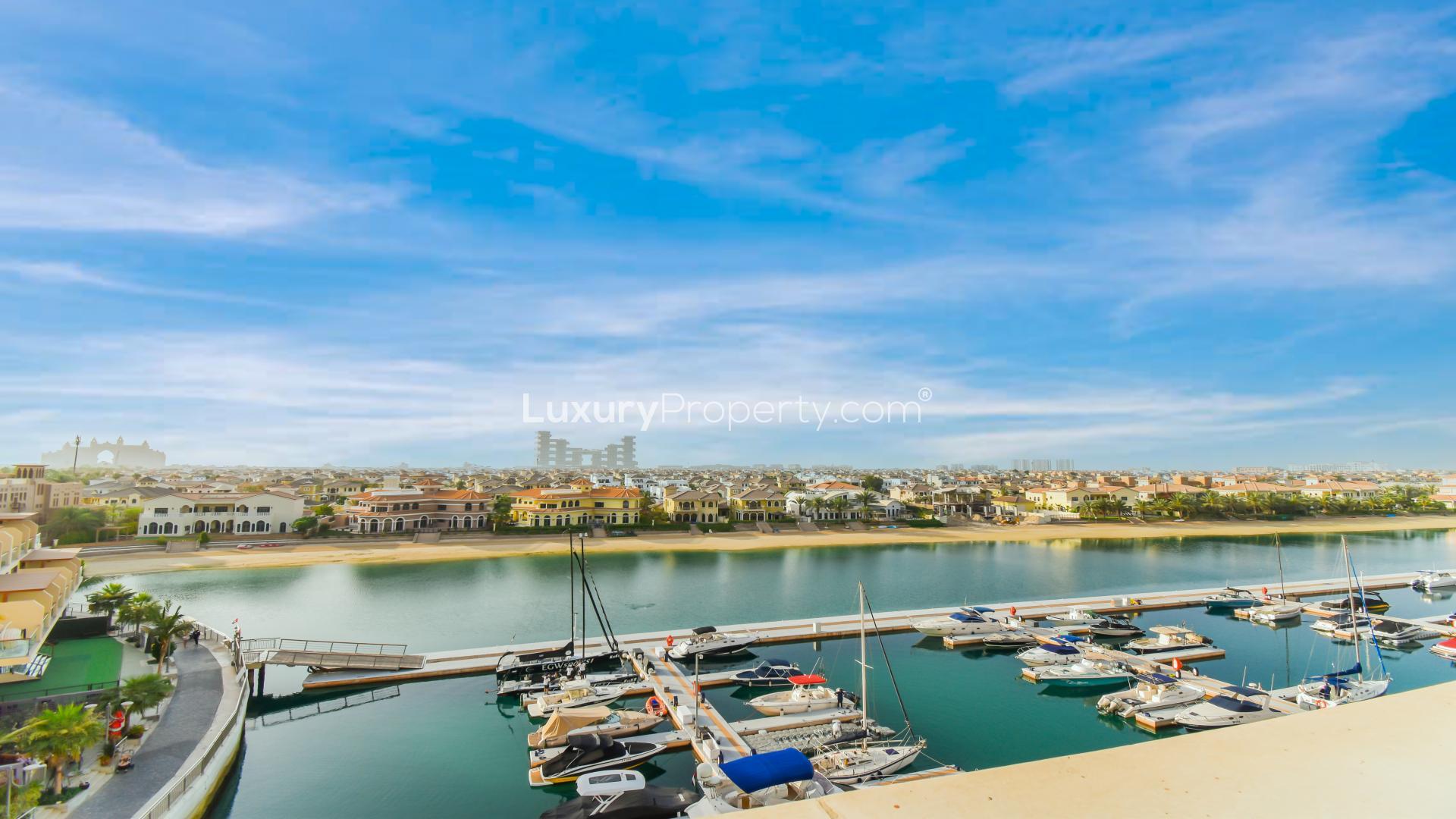 "Palm Jumeirah apartment balcony with stunning marina and Atlantis views, lush plant decor.","Palm Jumeirah Marina view from exclusive 3-bedroom apartment for sale in Marina Residences.",Palm Jumeirah Marina view from exclusive 3-bedroom apartment for sale in Marina Residences