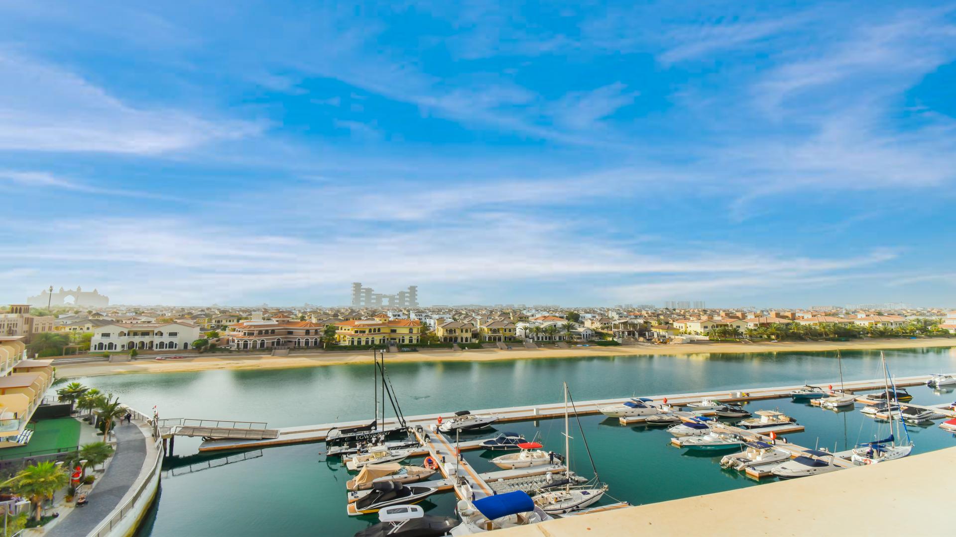 "Palm Jumeirah apartment balcony with stunning marina and Atlantis views, lush plant decor.","Palm Jumeirah Marina view from exclusive 3-bedroom apartment for sale in Marina Residences.",Palm Jumeirah Marina view from exclusive 3-bedroom apartment for sale in Marina Residences