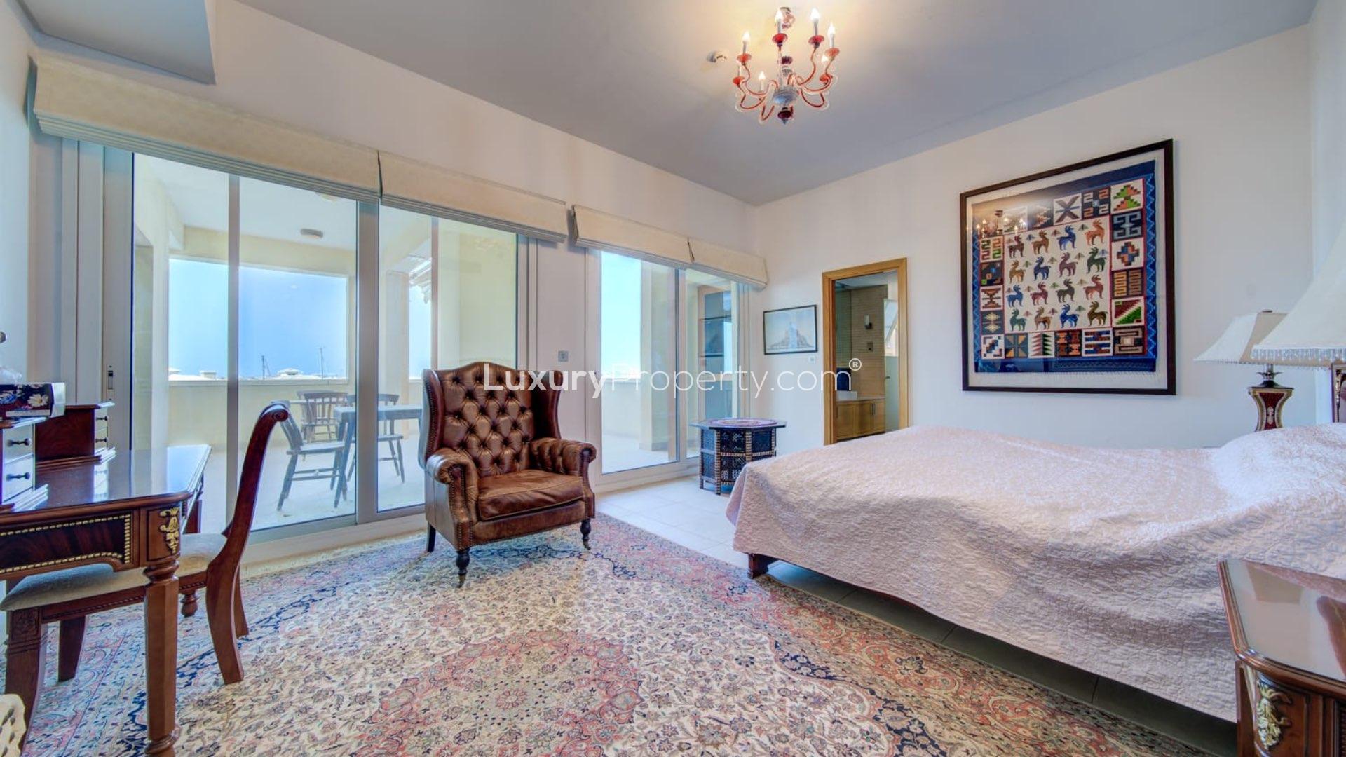 "Spacious terrace with sea view at Marina Residences, Palm Jumeirah apartment for sale.",Elegant bedroom in Palm Jumeirah apartment with terrace access and sea view