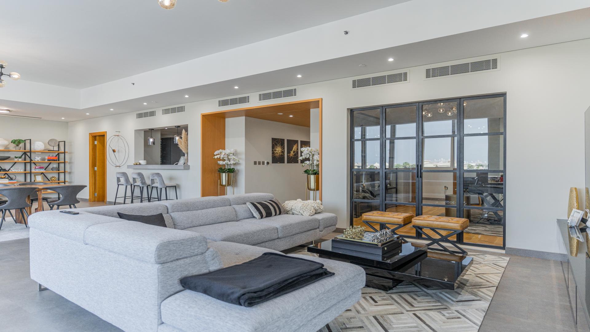 Luxurious Palm Jumeirah apartment terrace with views of Ain Dubai and Atlantis at night