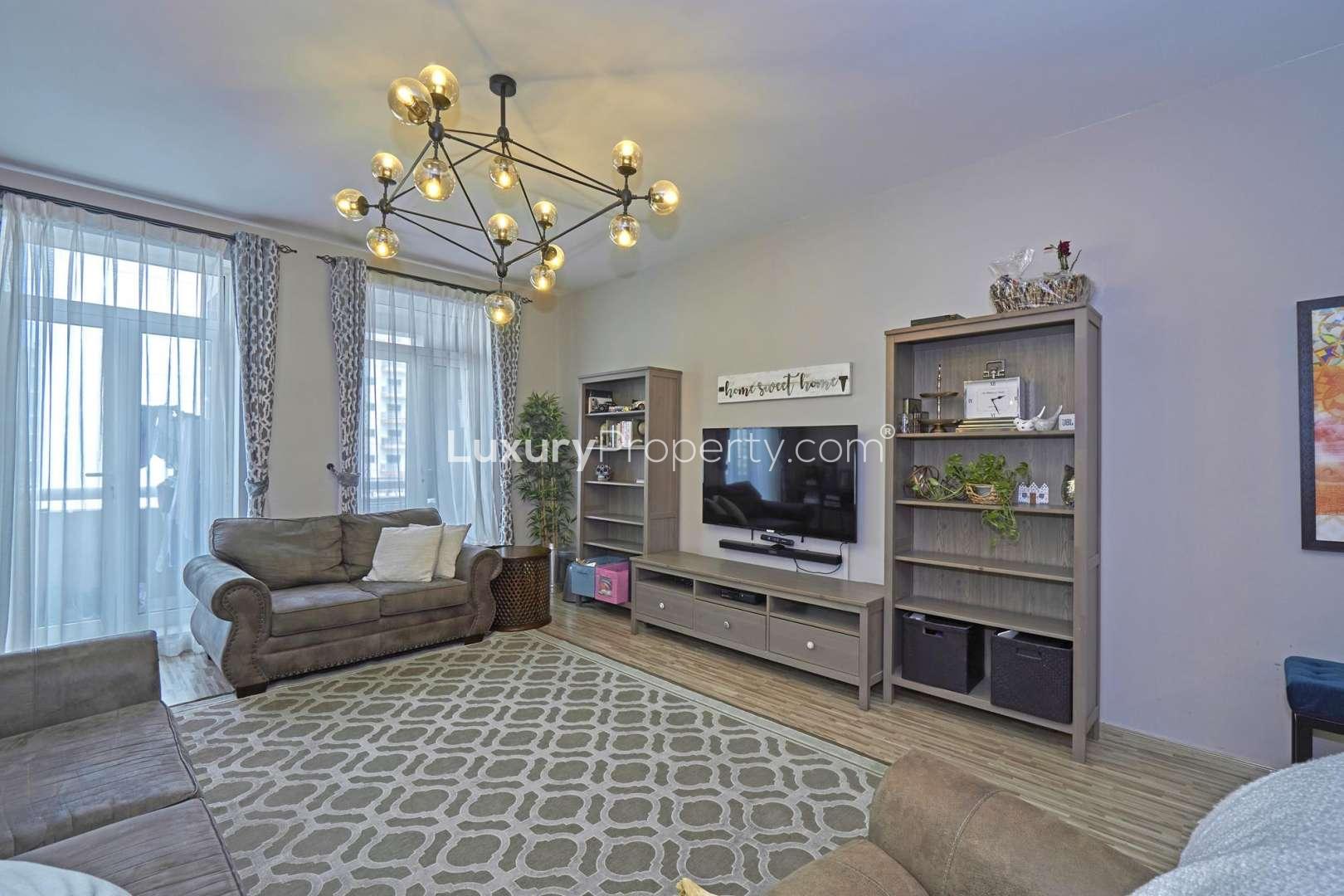 Dining area in 4-bed apartment, Masakin Al Furjan, elegant decor, wooden table, modern lighting