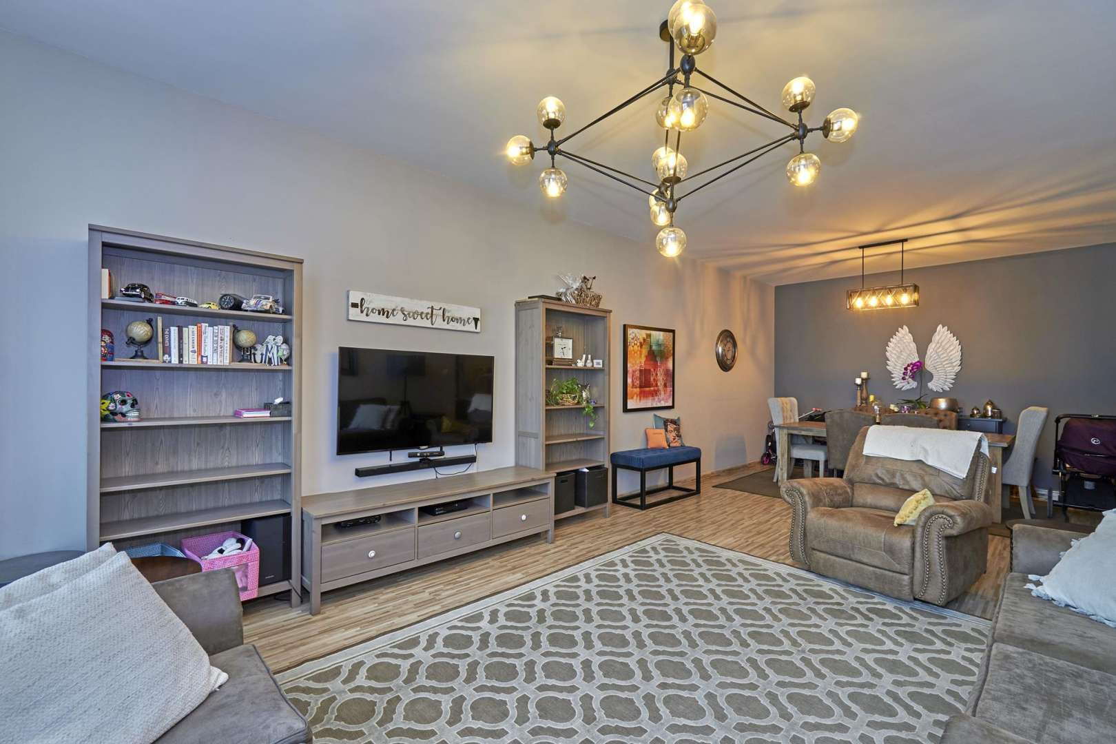 Beautiful pool area at Masakin Al Furjan apartment complex with palm trees and sun loungers