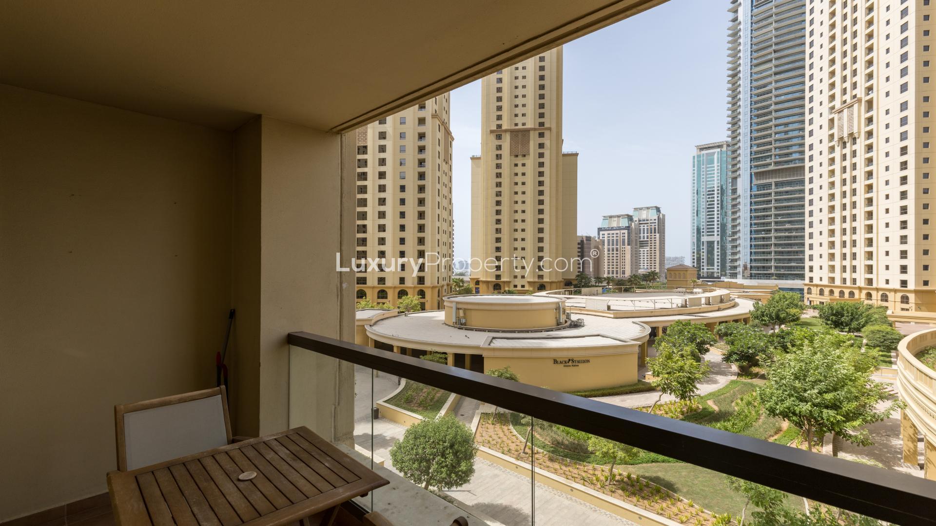Beautifully furnished living room in Jumeirah Beach Residence apartment, vibrant decor and cozy seating