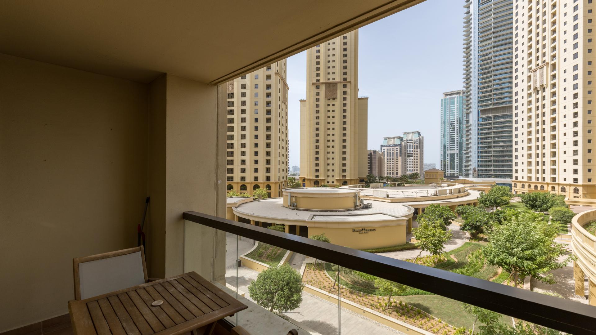 Beautifully furnished living room in Jumeirah Beach Residence apartment, vibrant decor and cozy seating