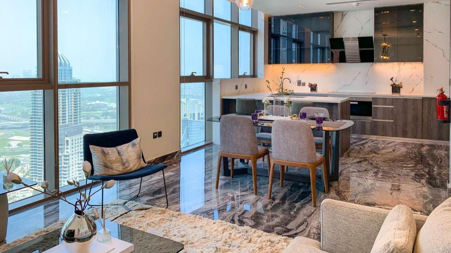 "Dubai Marina apartment balcony with stunning views, three-bedroom property for sale.",Modern Dubai Marina apartment interior with elegant dining area and stunning city views