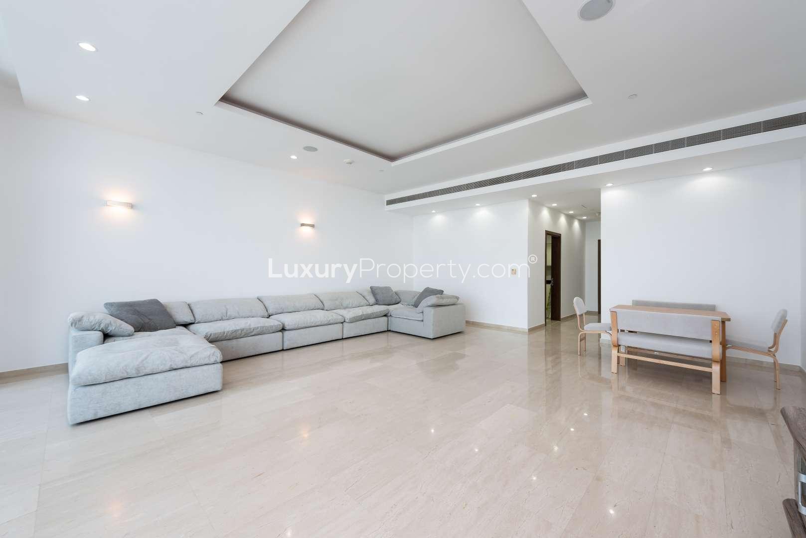 High-floor apartment living room with large windows, Palm Jumeirah views, Oceana community