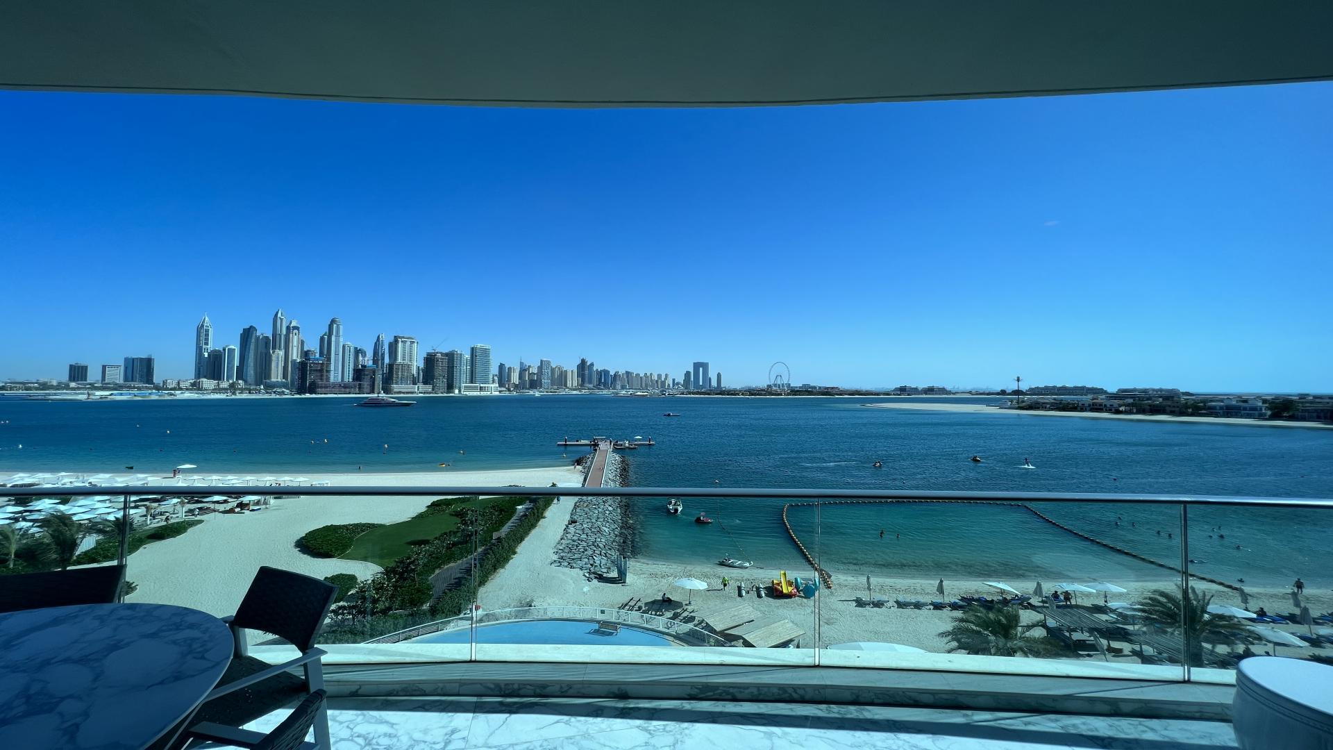 Modern living room with marble floors, ocean views, Palm Jumeirah apartment for sale