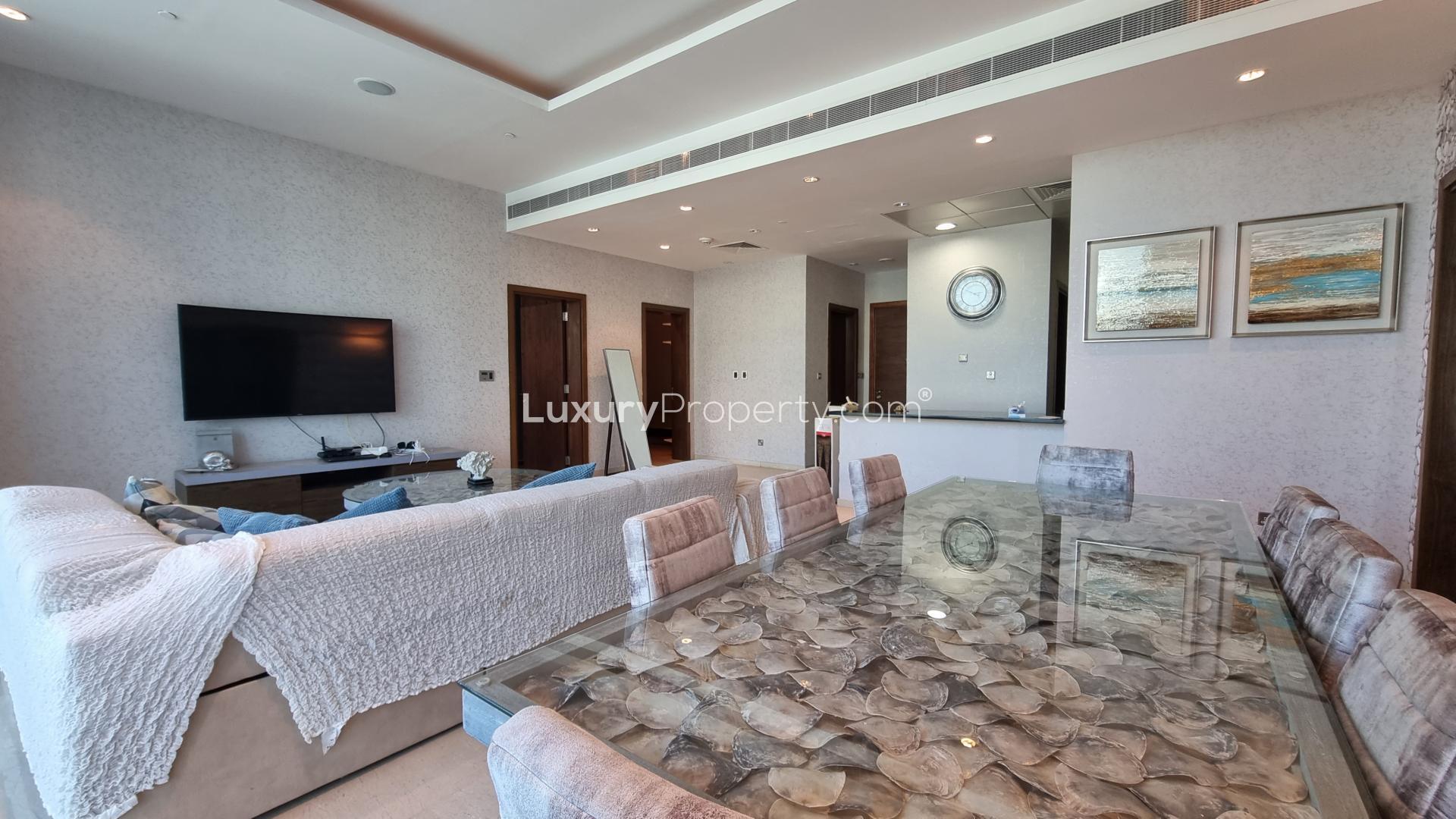 Spacious living room in Palm Jumeirah apartment with skyline views, modern decor, and natural light