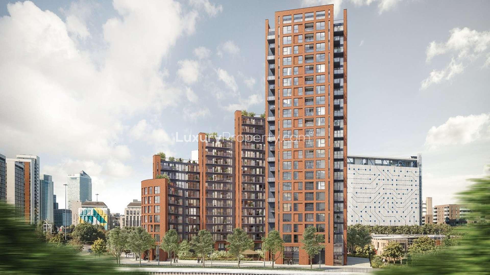 Exterior view of Orchard Wharf riverside apartment complex in London for sale.